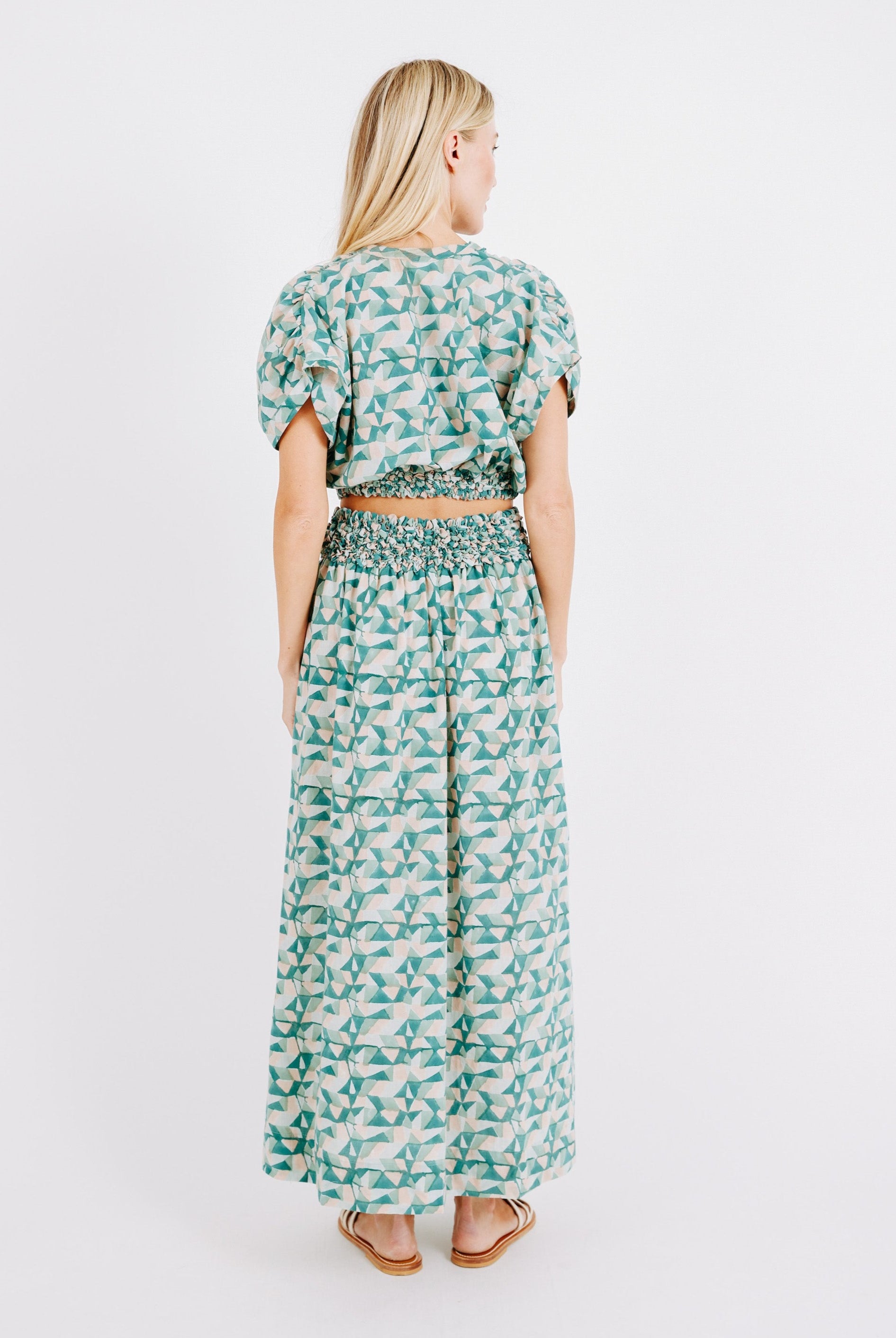 Girl wearing MIRTH women's smocked elastic waist cropped granada top set in seaglass green