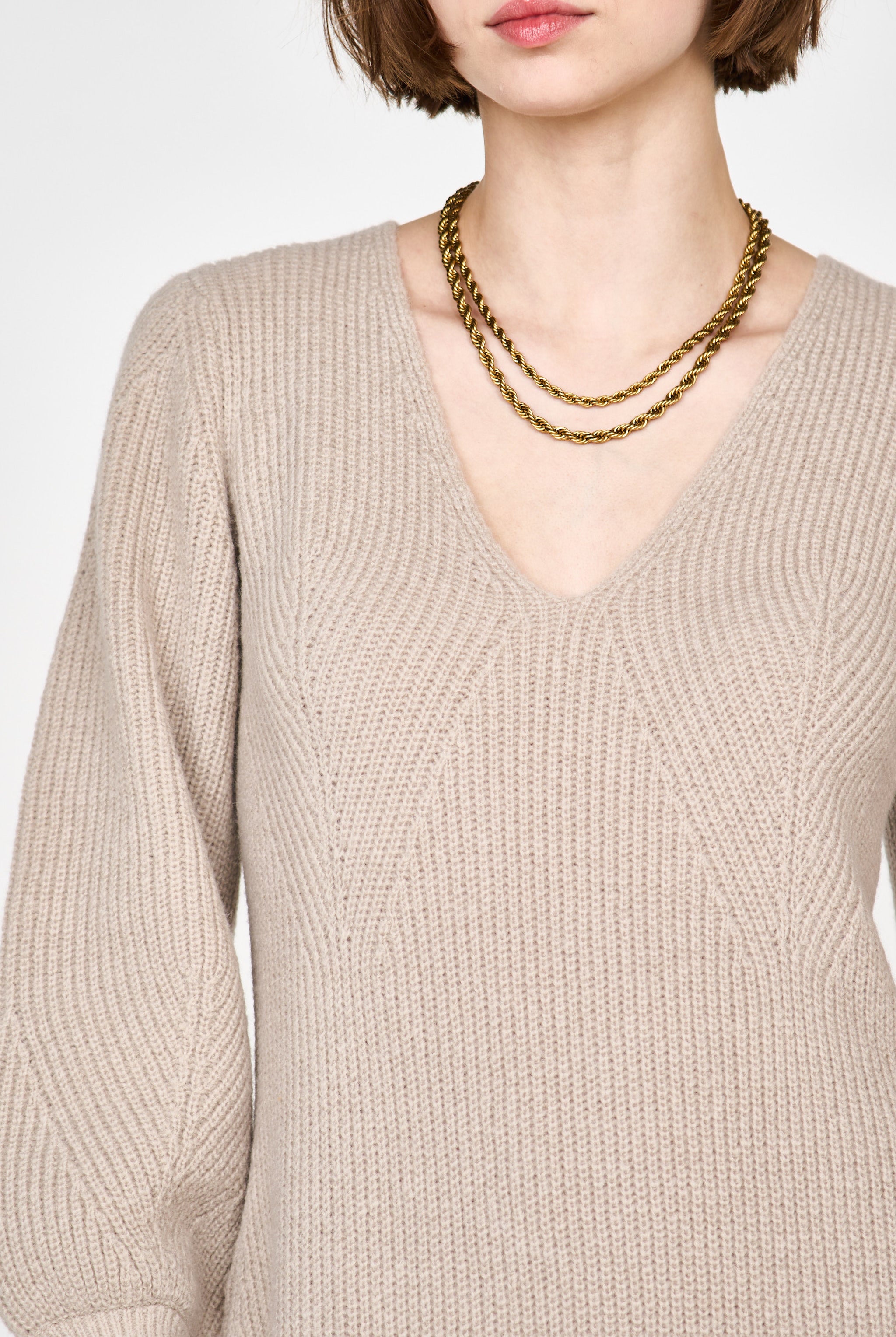 Girl wearing MIRTH women's knit v neck bellagio sweater dress in taupe brown wool