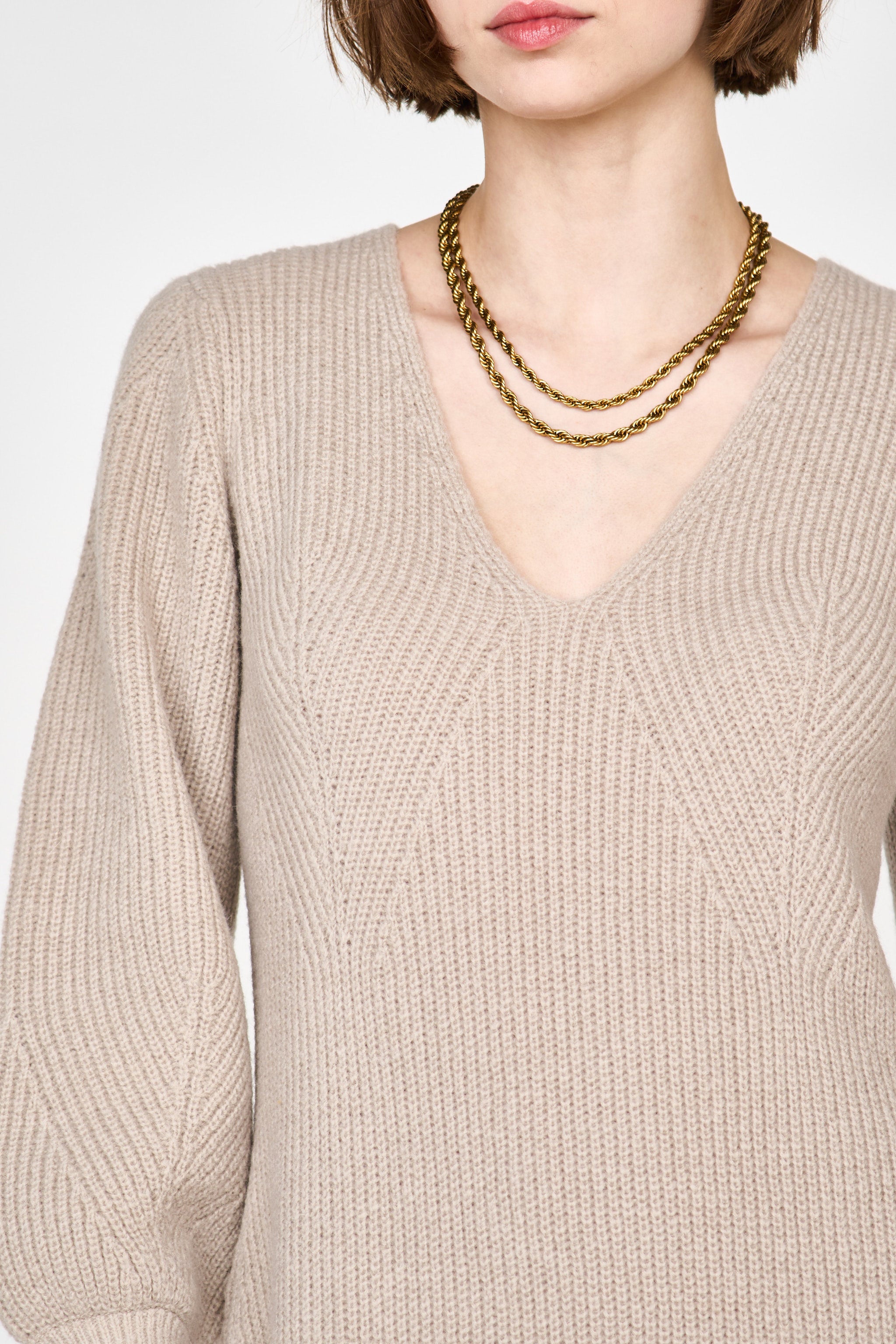 Girl wearing MIRTH women's knit v neck bellagio sweater dress in taupe brown wool