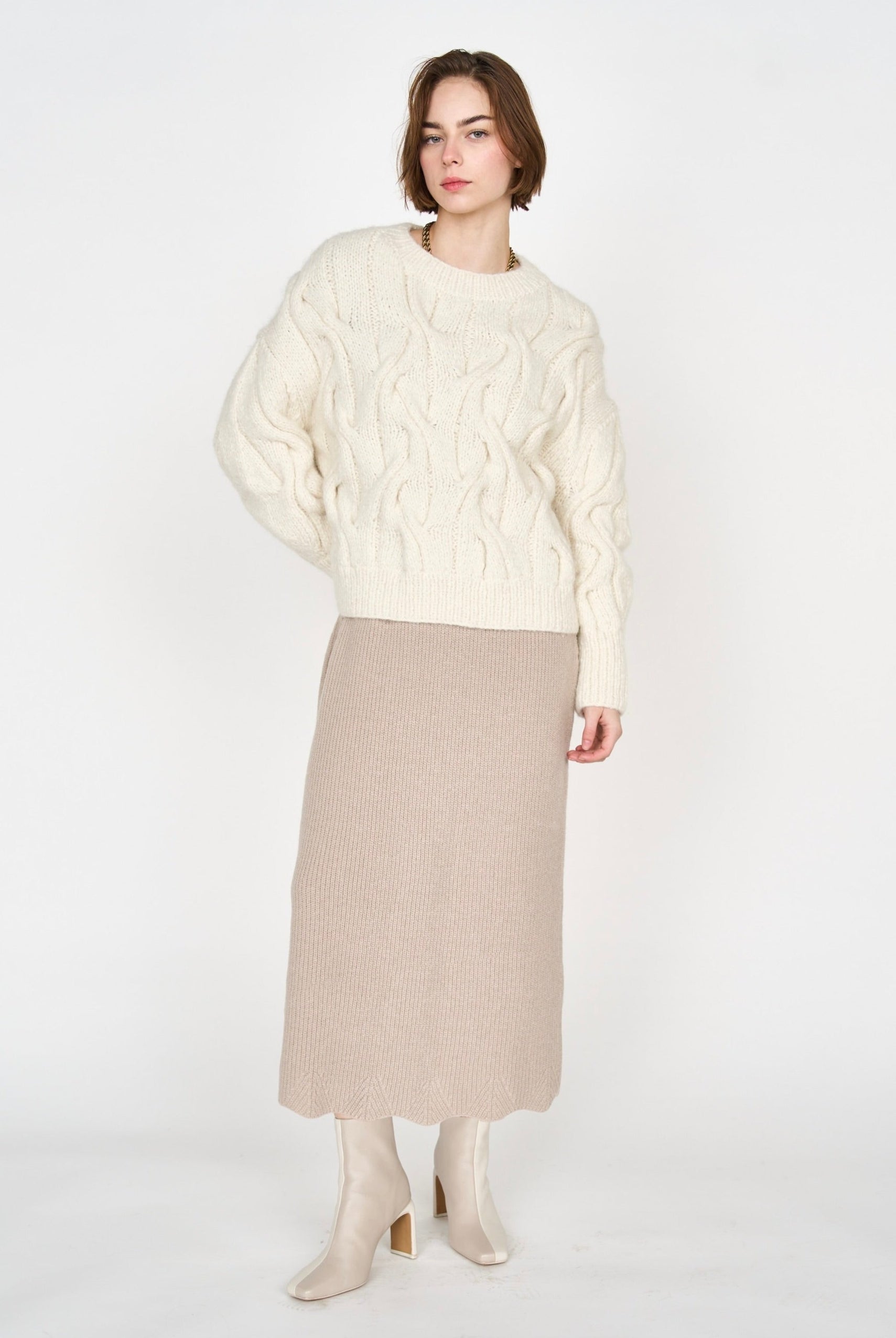 Girl wearing MIRTH women's handknit cortina cable pullover sweater in cream white wool