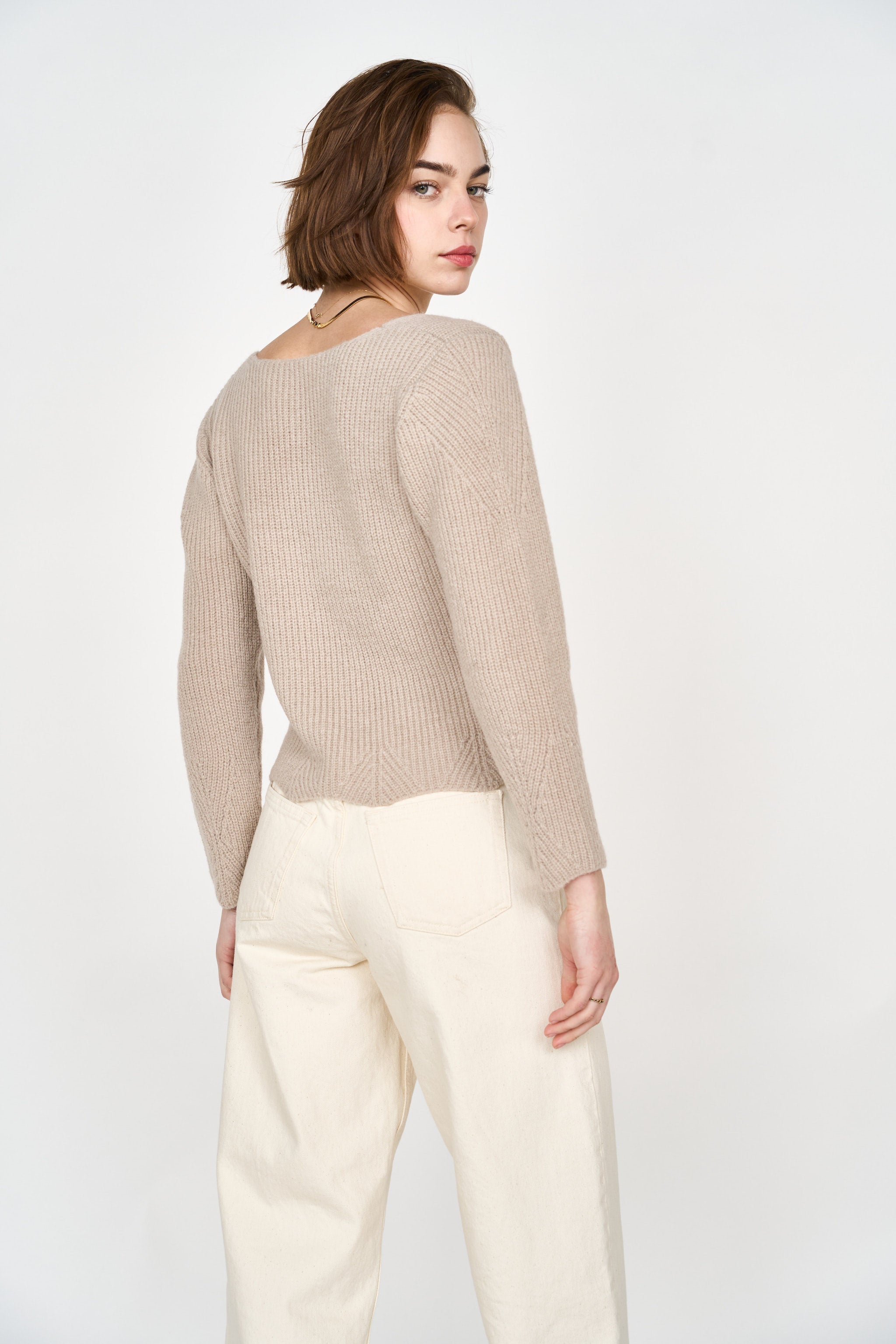 Girl wearing MIRTH women's knit v neck bellagio sweater in taupe brown wool