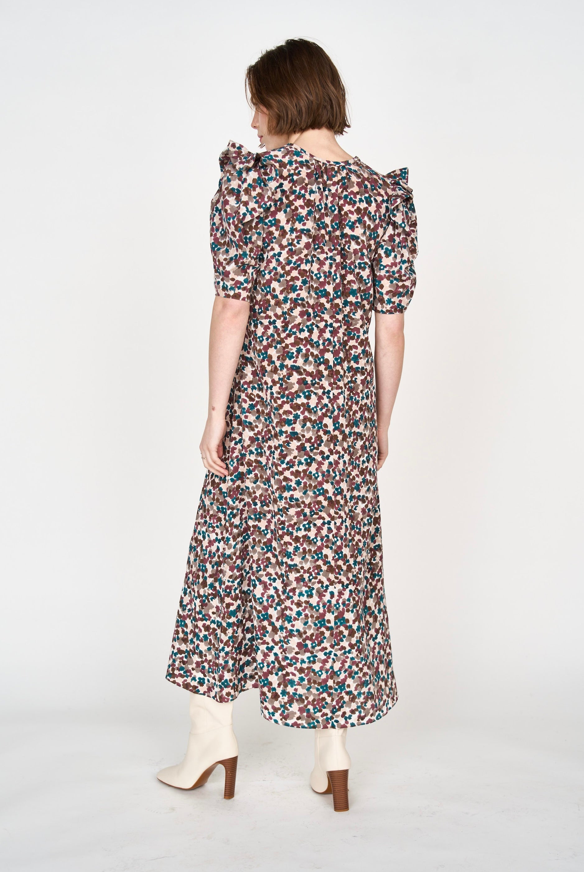 Girl wearing MIRTH women's puff sleeve v neck long cassis dress in purple brown amaryllis silk