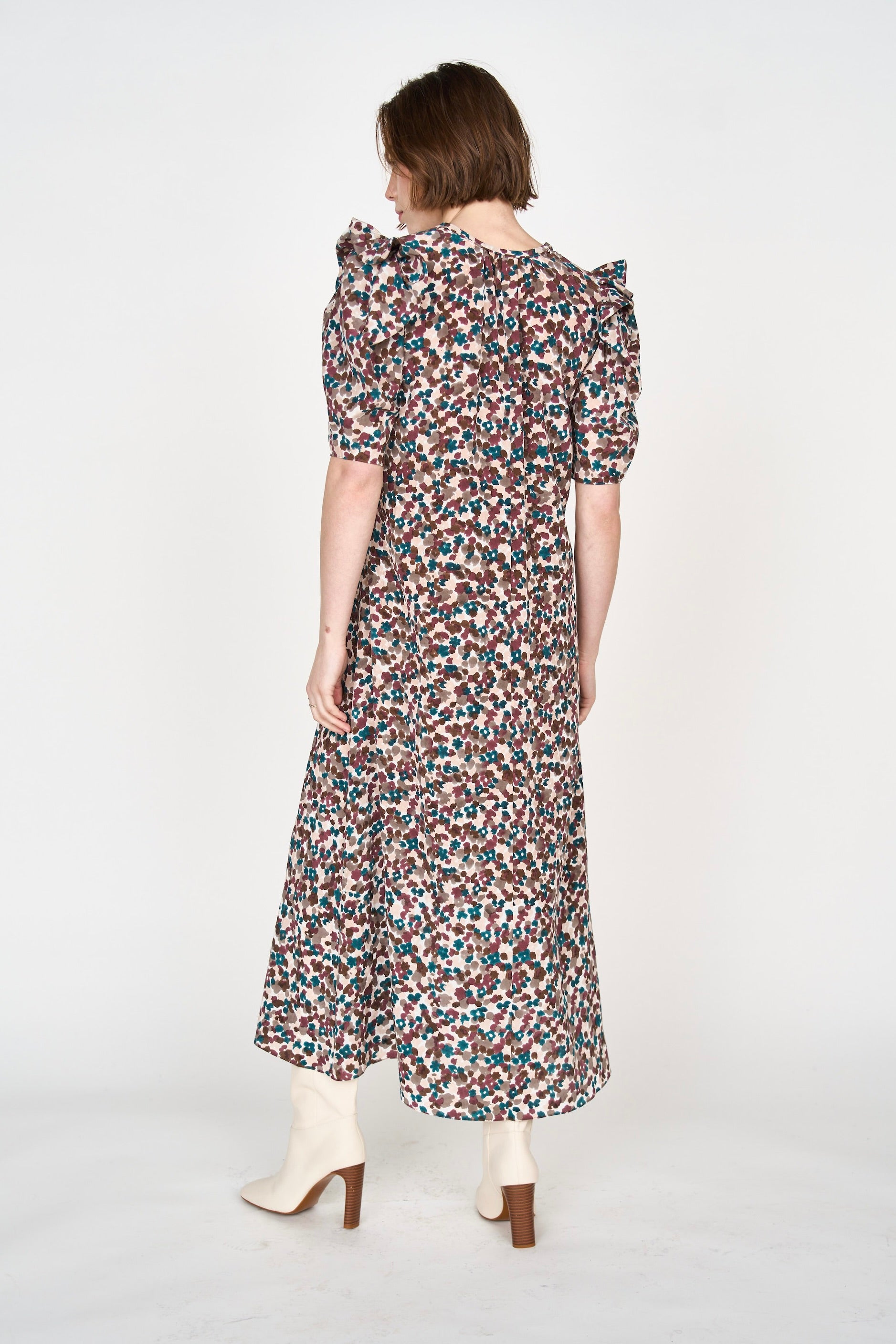 Girl wearing MIRTH women's puff sleeve v neck long cassis dress in purple brown amaryllis silk