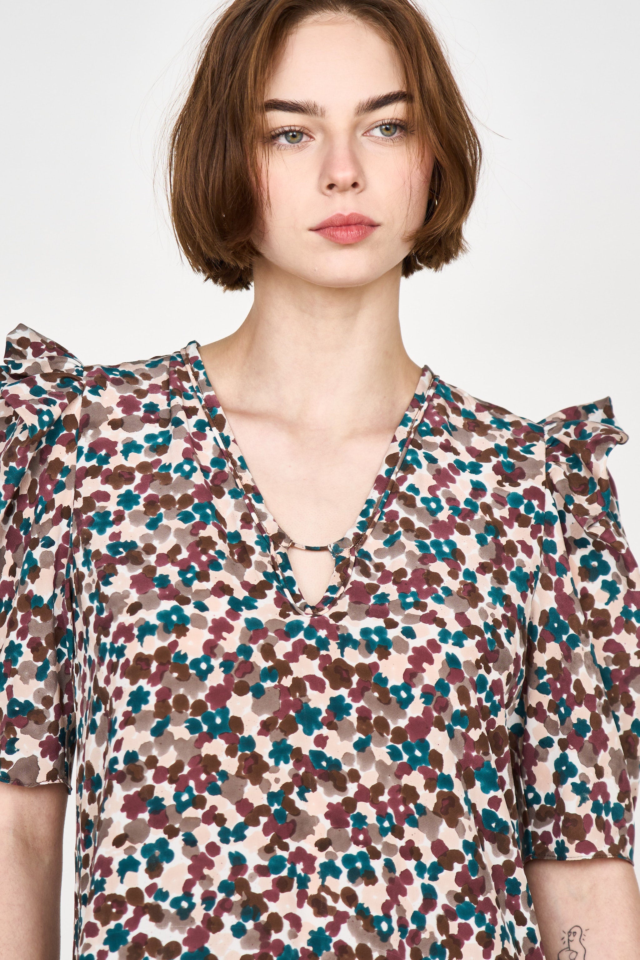 Girl wearing MIRTH women's puff sleeve v neck long cassis dress in purple brown amaryllis silk