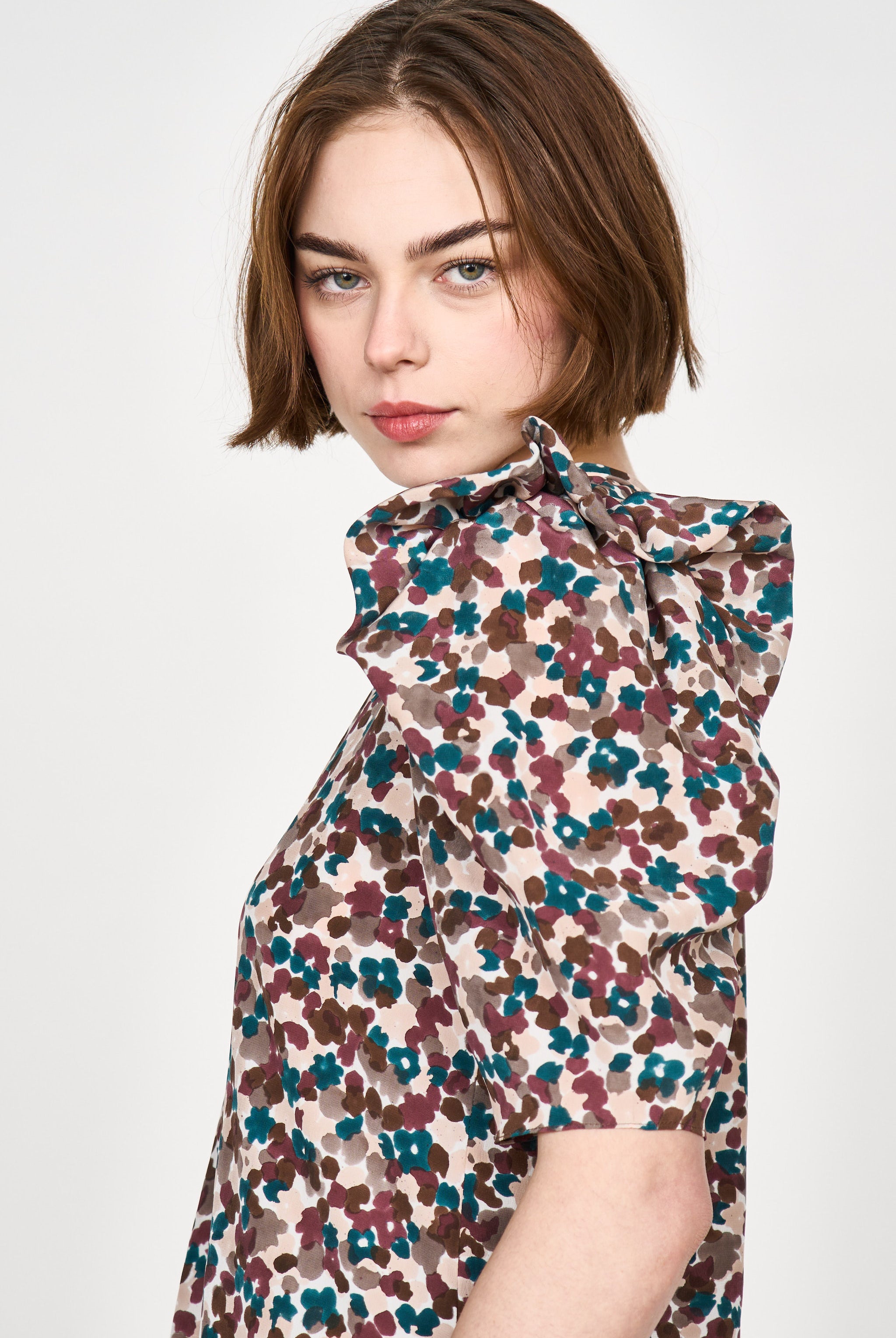 Girl wearing MIRTH women's puff sleeve v neck long cassis dress in purple brown amaryllis silk