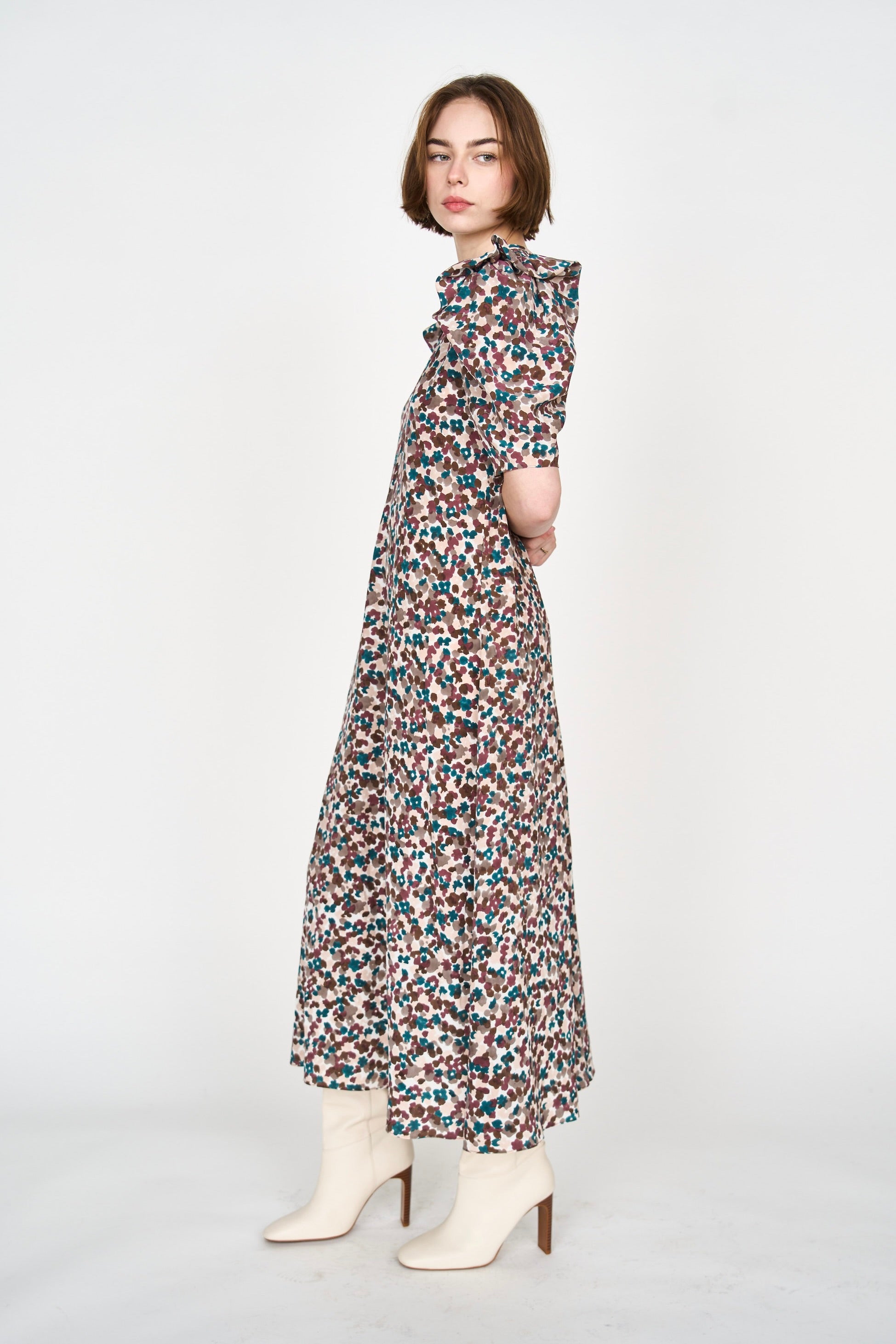 Girl wearing MIRTH women's puff sleeve v neck long cassis dress in purple brown amaryllis silk