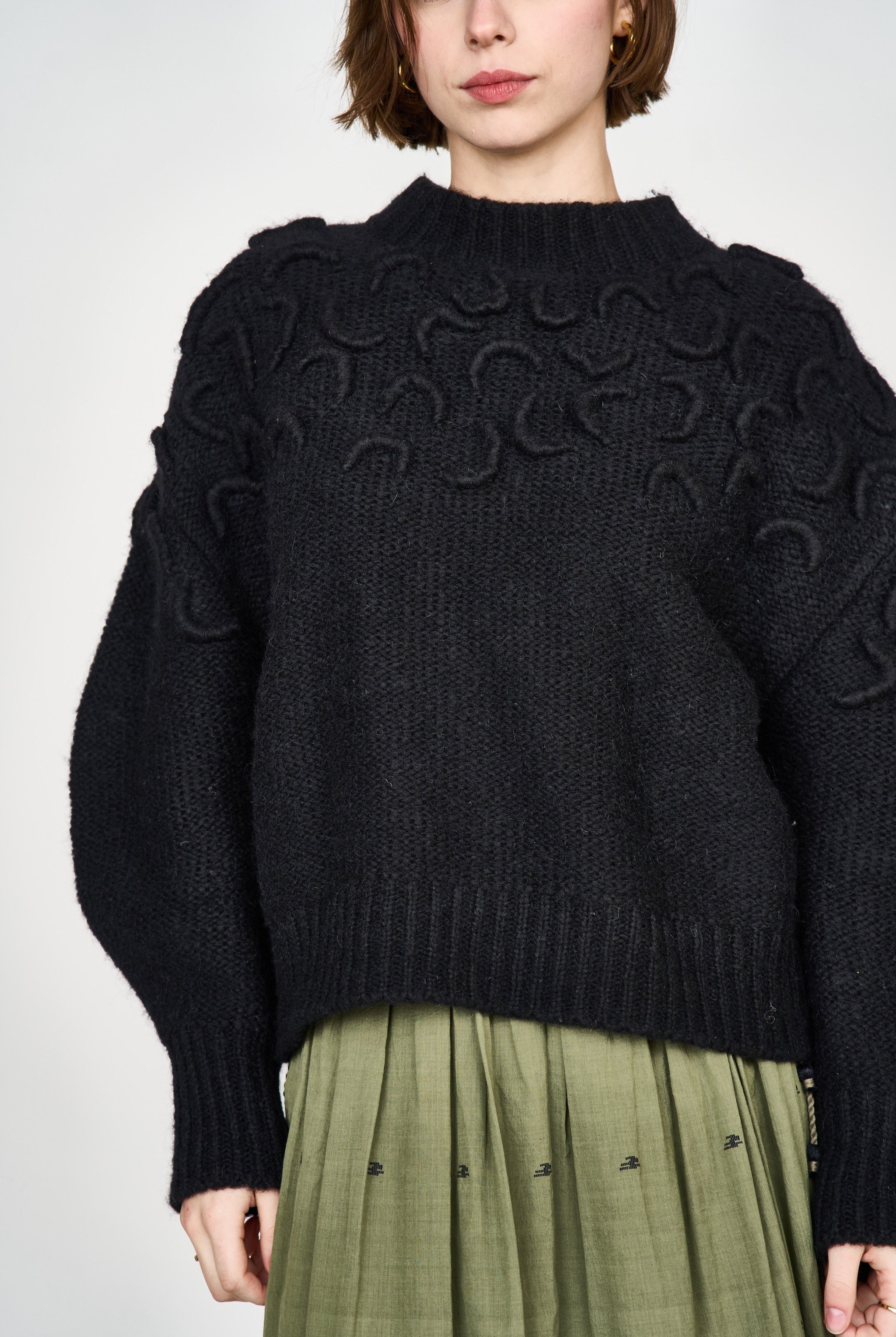 Girl wearing MIRTH women's knit cusco pullover sweater in black wool