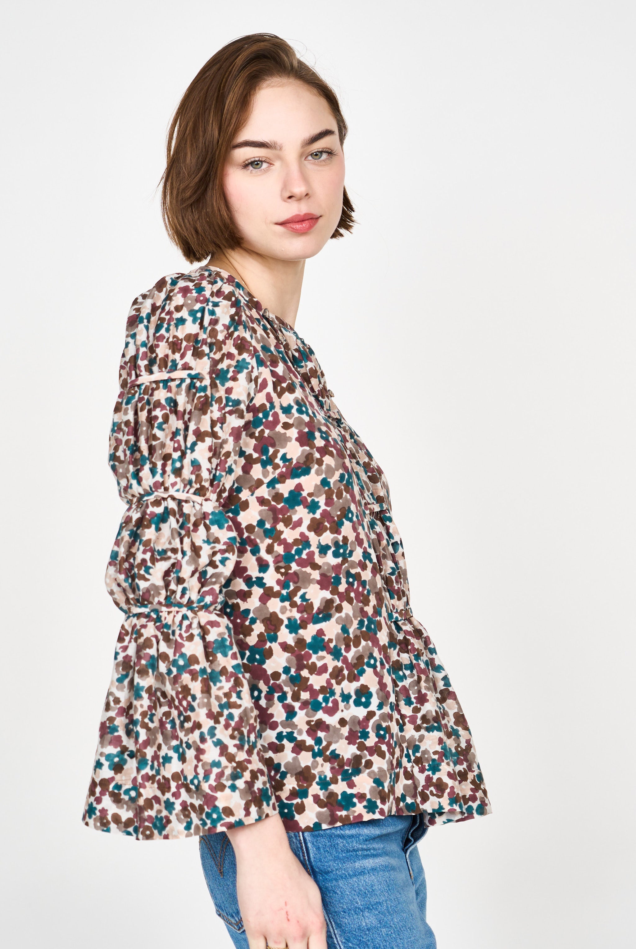 Girl wearing MIRTH women's elastic tier long sleeve fez blouse in purple brown amaryllis silk