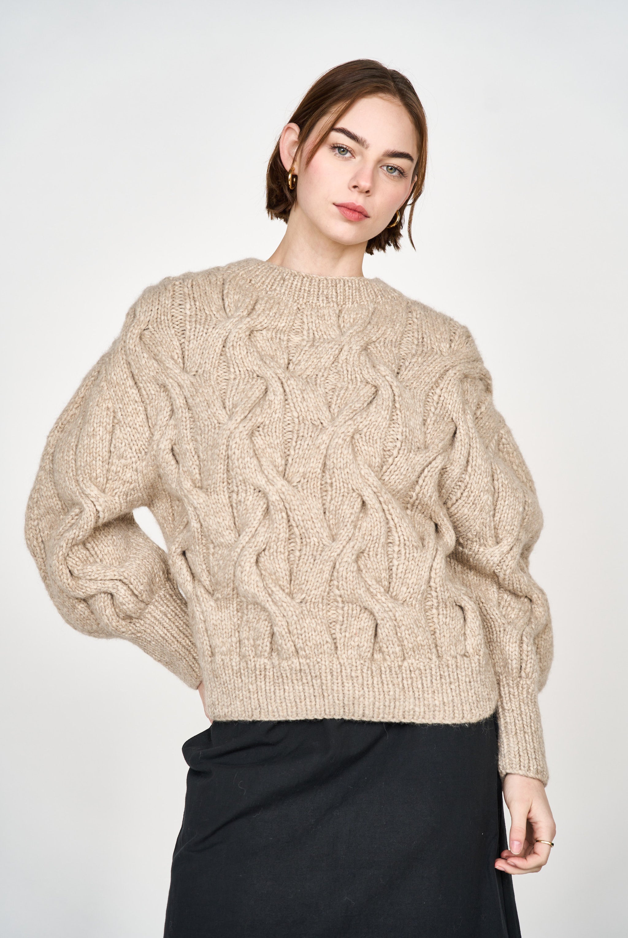 Girl wearing MIRTH women's handknit cortina cable pullover sweater in camel brown wool