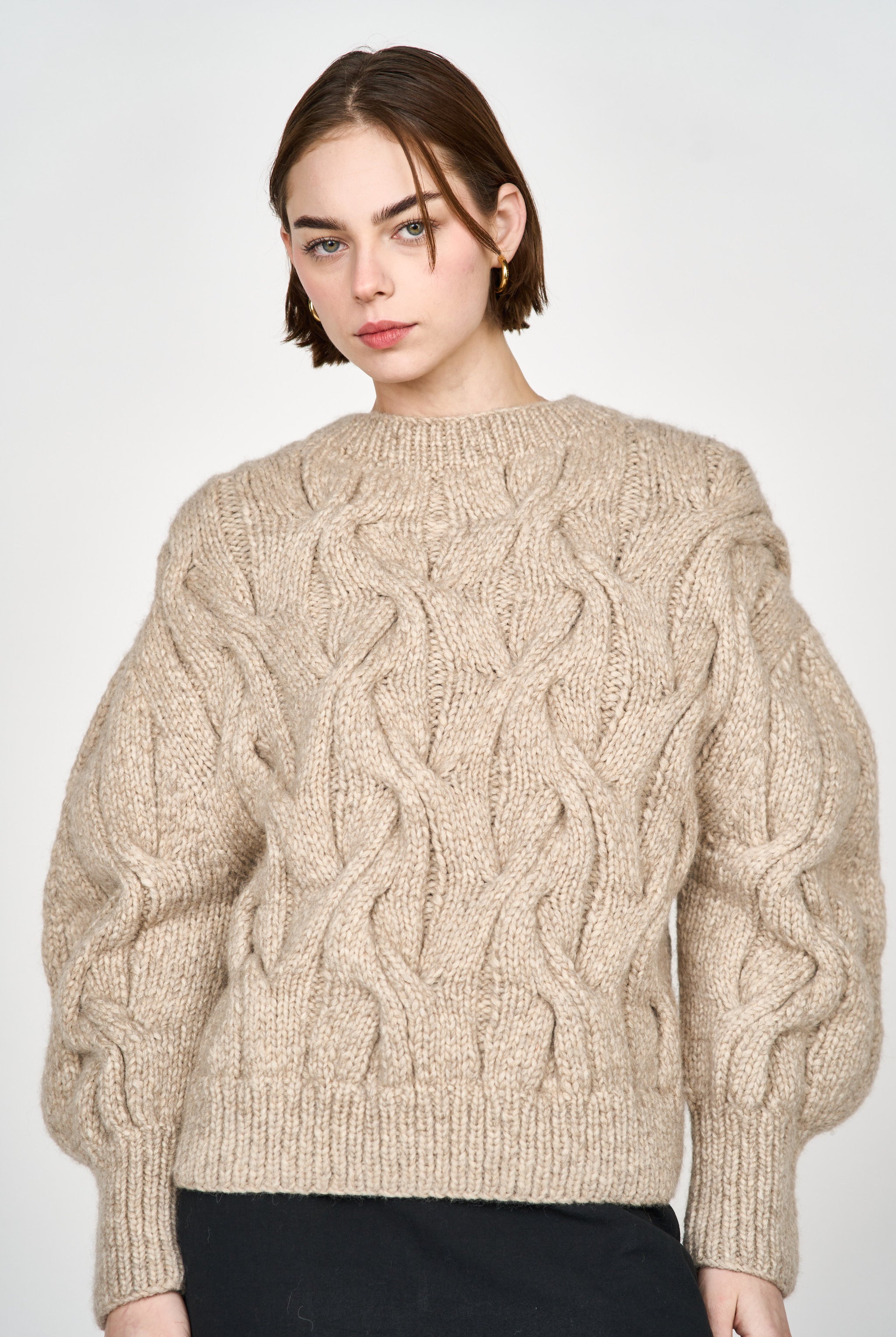 Girl wearing MIRTH women's handknit cortina cable pullover sweater in camel brown wool