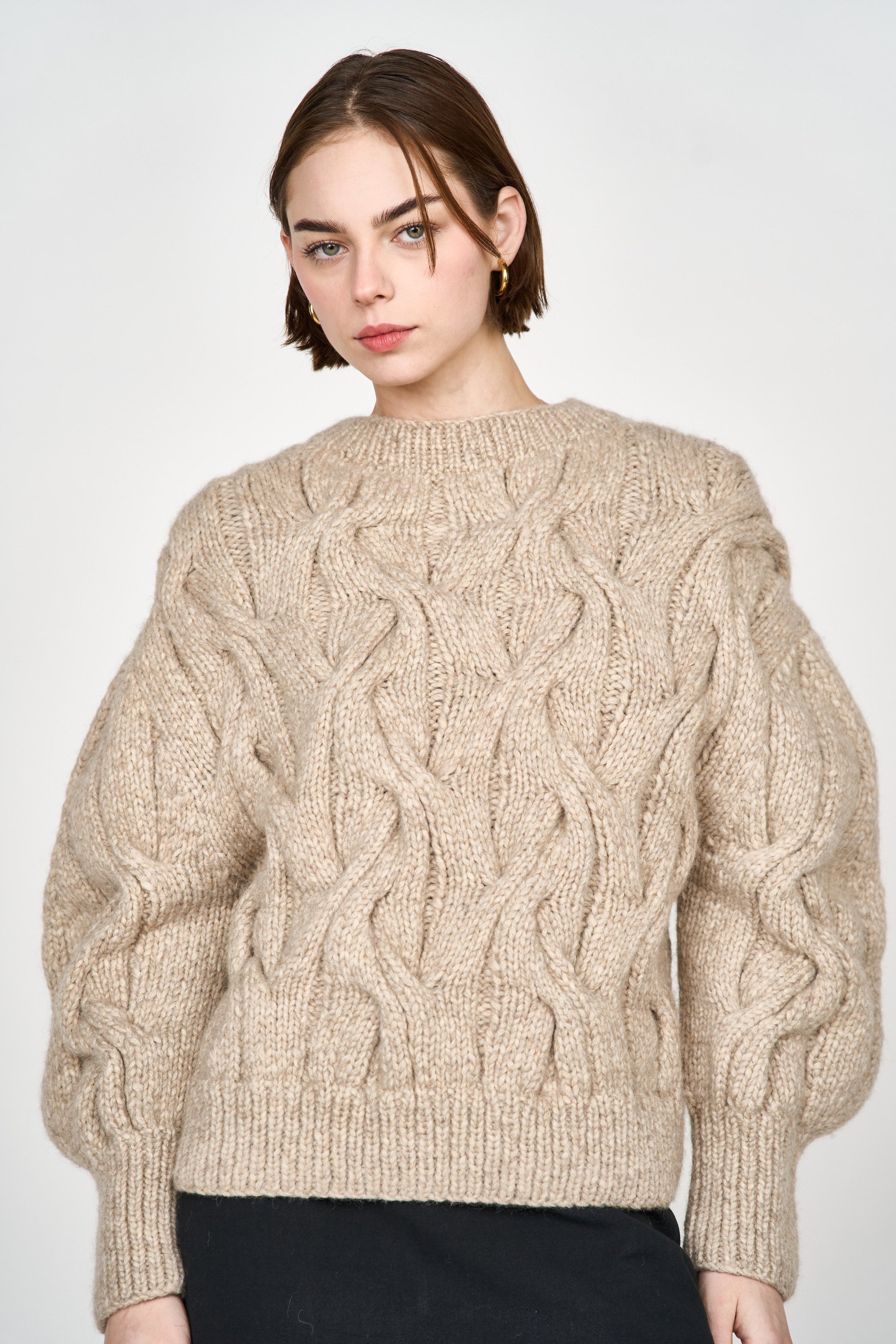 Girl wearing MIRTH women's handknit cortina cable pullover sweater in camel brown wool