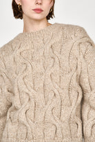 Girl wearing MIRTH women's handknit cortina cable pullover sweater in camel brown wool