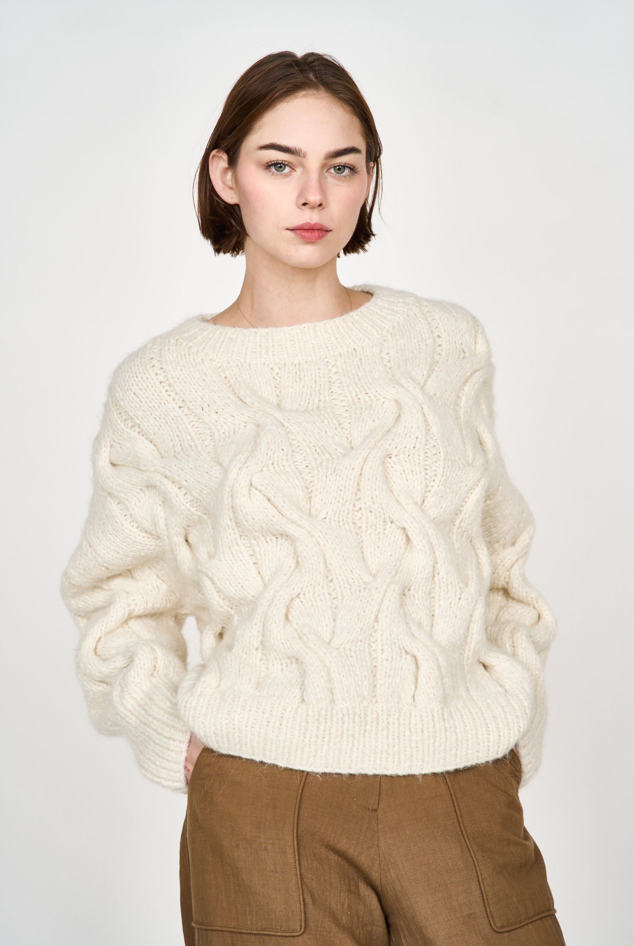 Girl wearing MIRTH women's handknit cortina cable pullover sweater in cream white wool