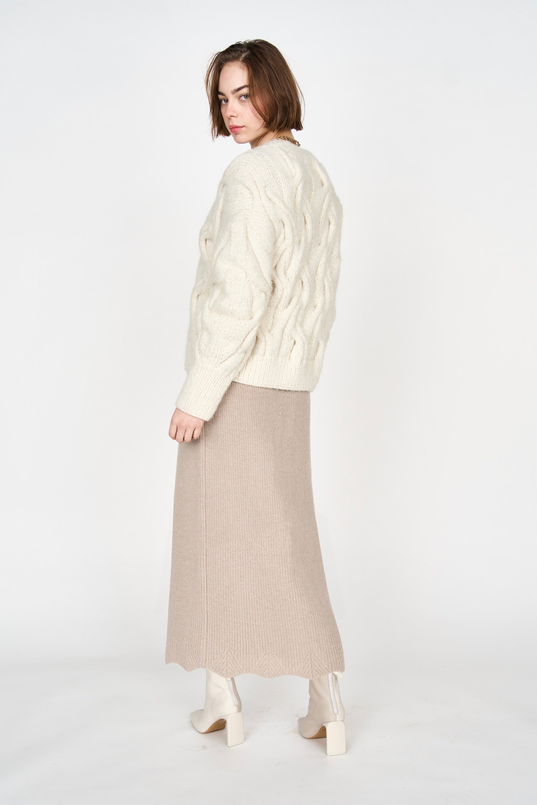 Girl wearing MIRTH women's handknit cortina cable pullover sweater in cream white wool