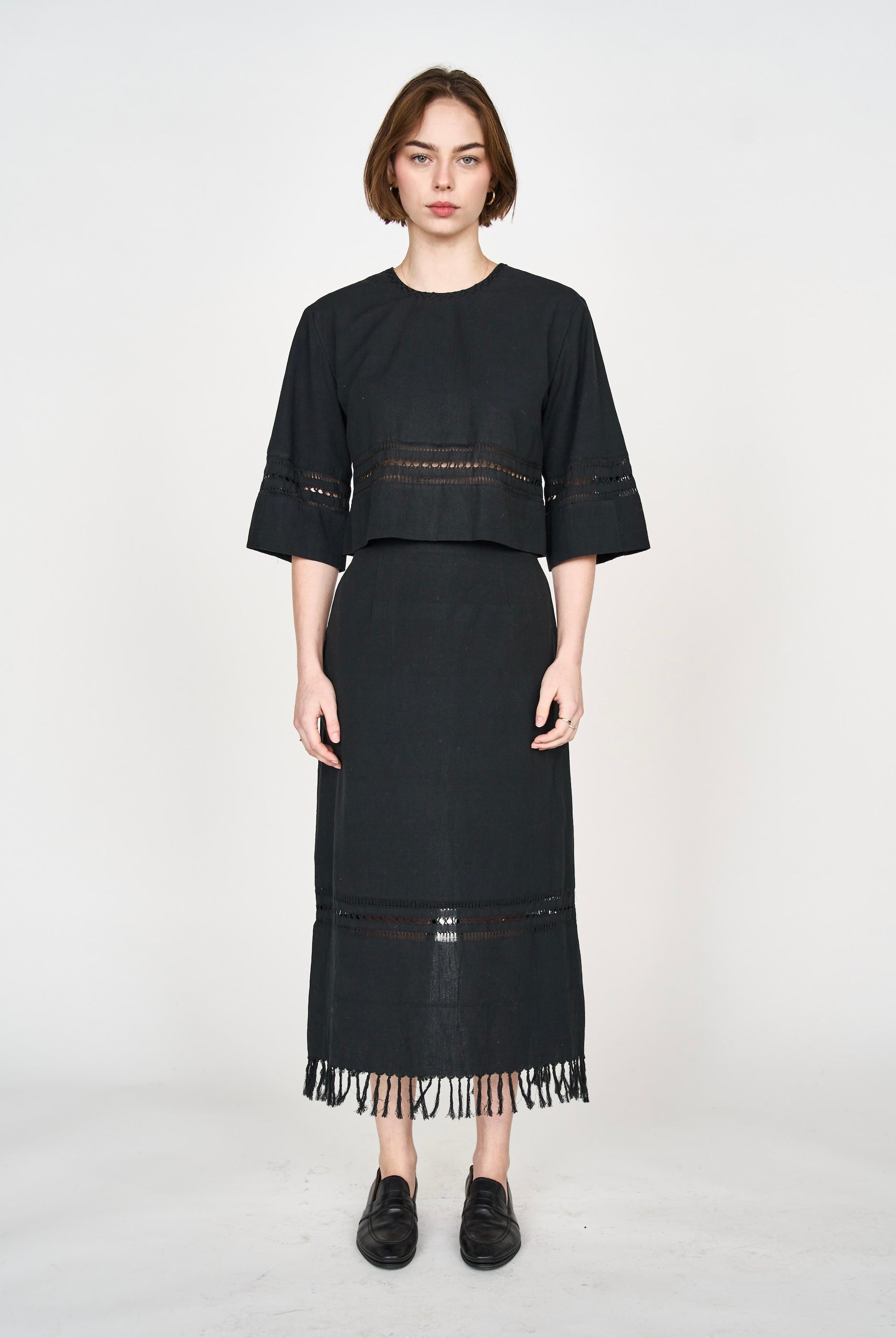 Girl wearing MIRTH women's midi fringe cutout lombok skirt in black cotton