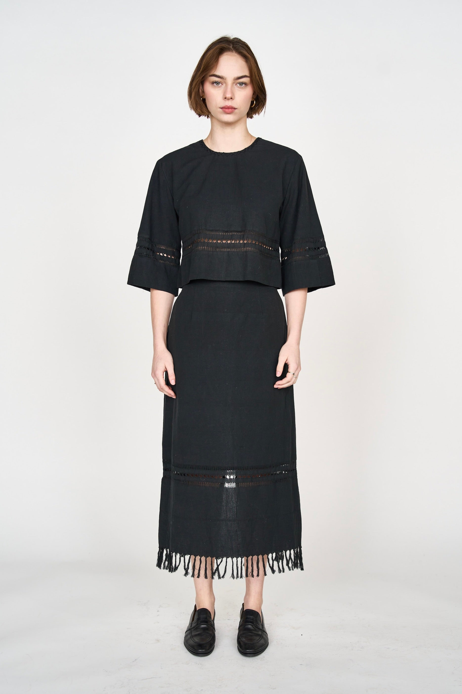Girl wearing MIRTH women's midi fringe cutout lombok skirt in black cotton
