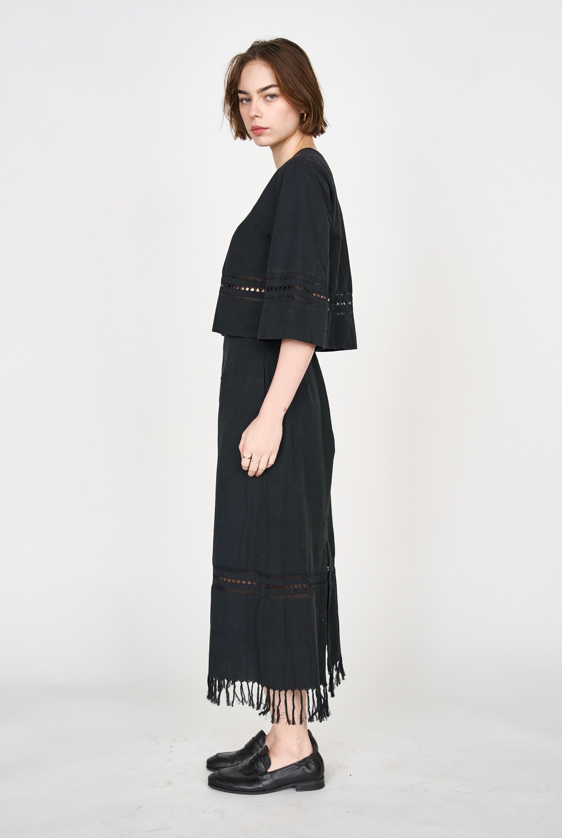 Girl wearing MIRTH women's midi fringe cutout lombok skirt in black cotton