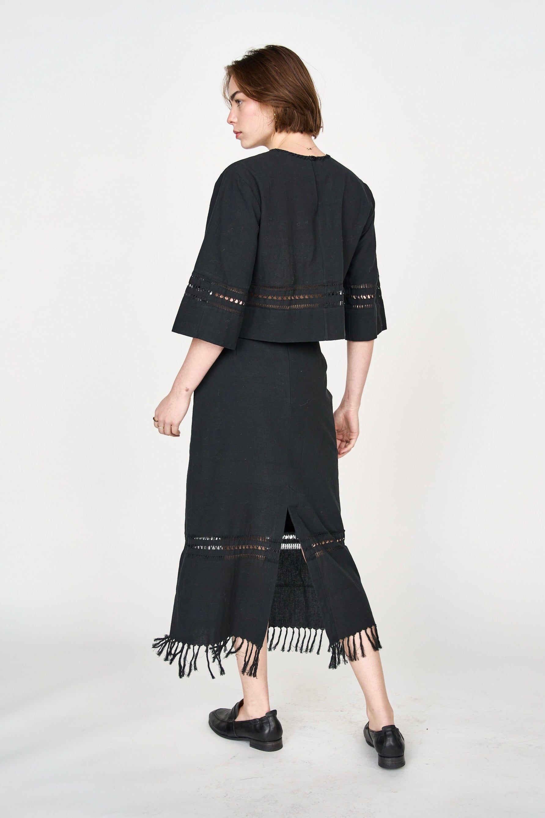 Girl wearing MIRTH women's midi fringe cutout lombok skirt in black cotton