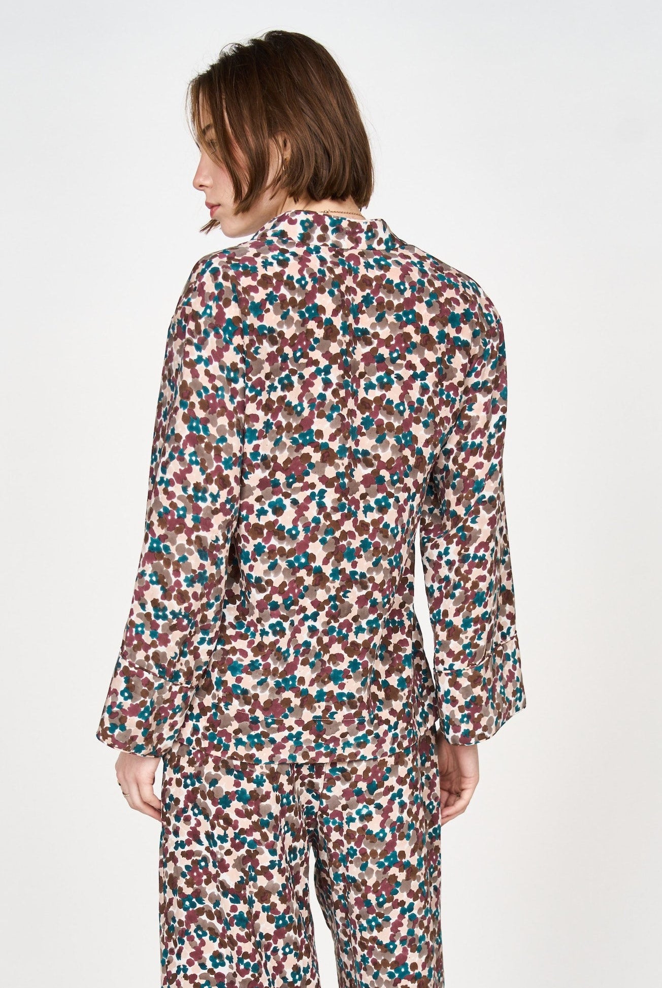 Girl wearing MIRTH women's button down collared long sleeve malmo shirt in purple brown amaryllis silk