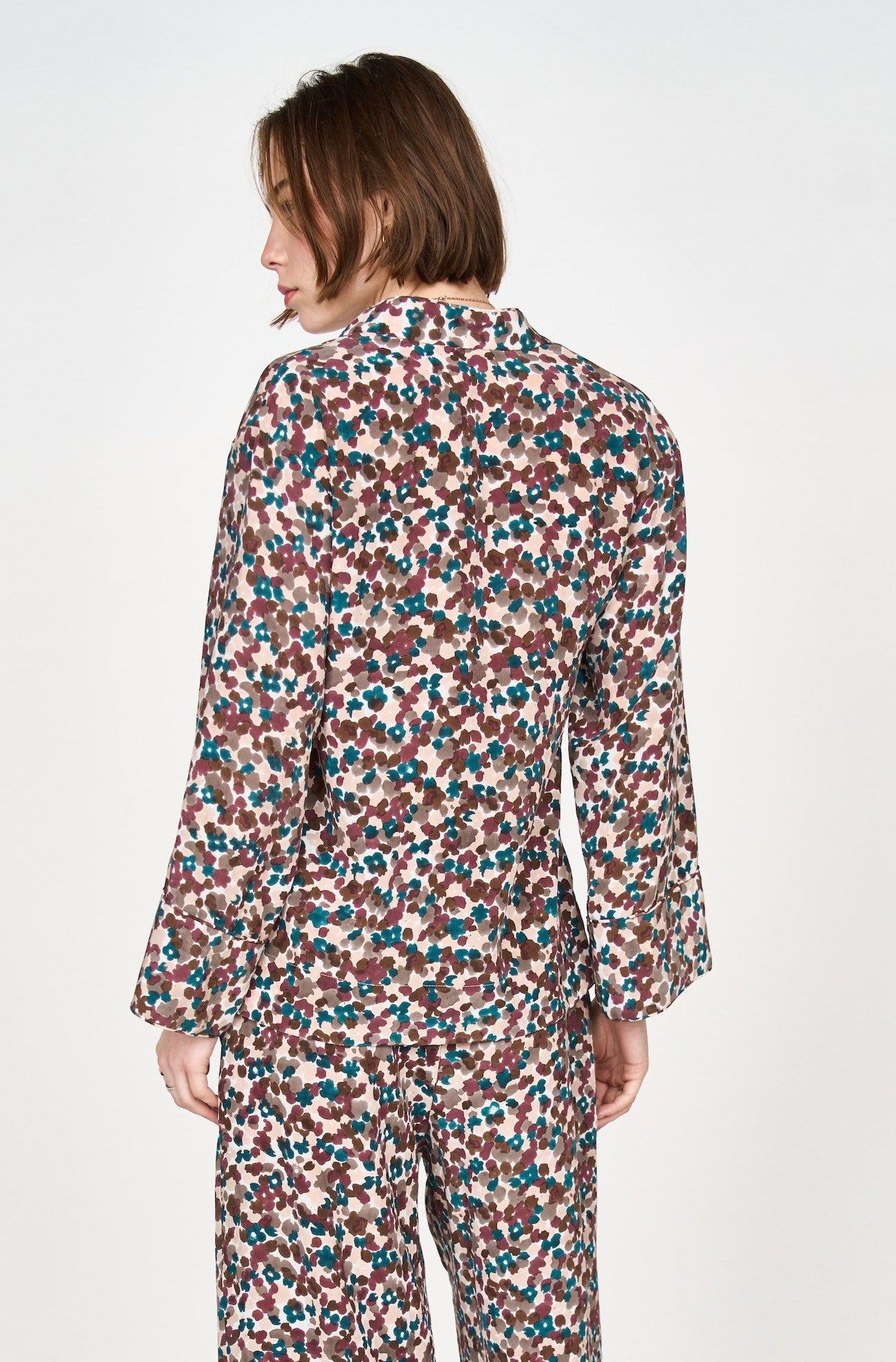 Girl wearing MIRTH women's button down collared long sleeve malmo shirt in purple brown amaryllis silk