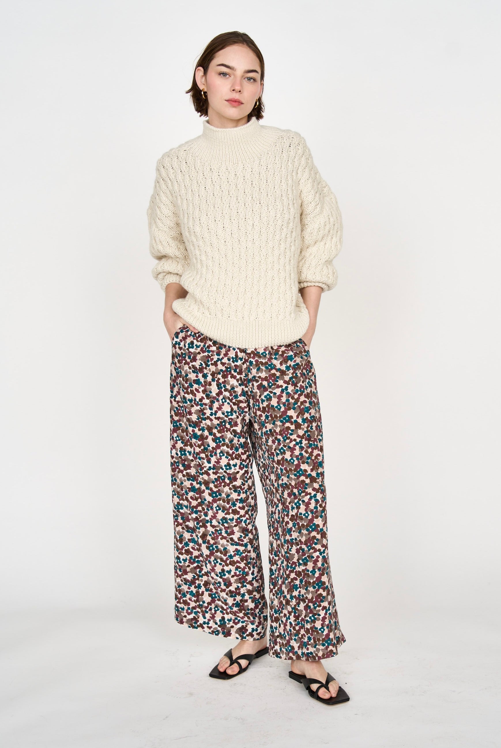 Girl wearing MIRTH women's pullover hand knit honeycomb weave megeve turtleneck sweater in ivory alpaca wool