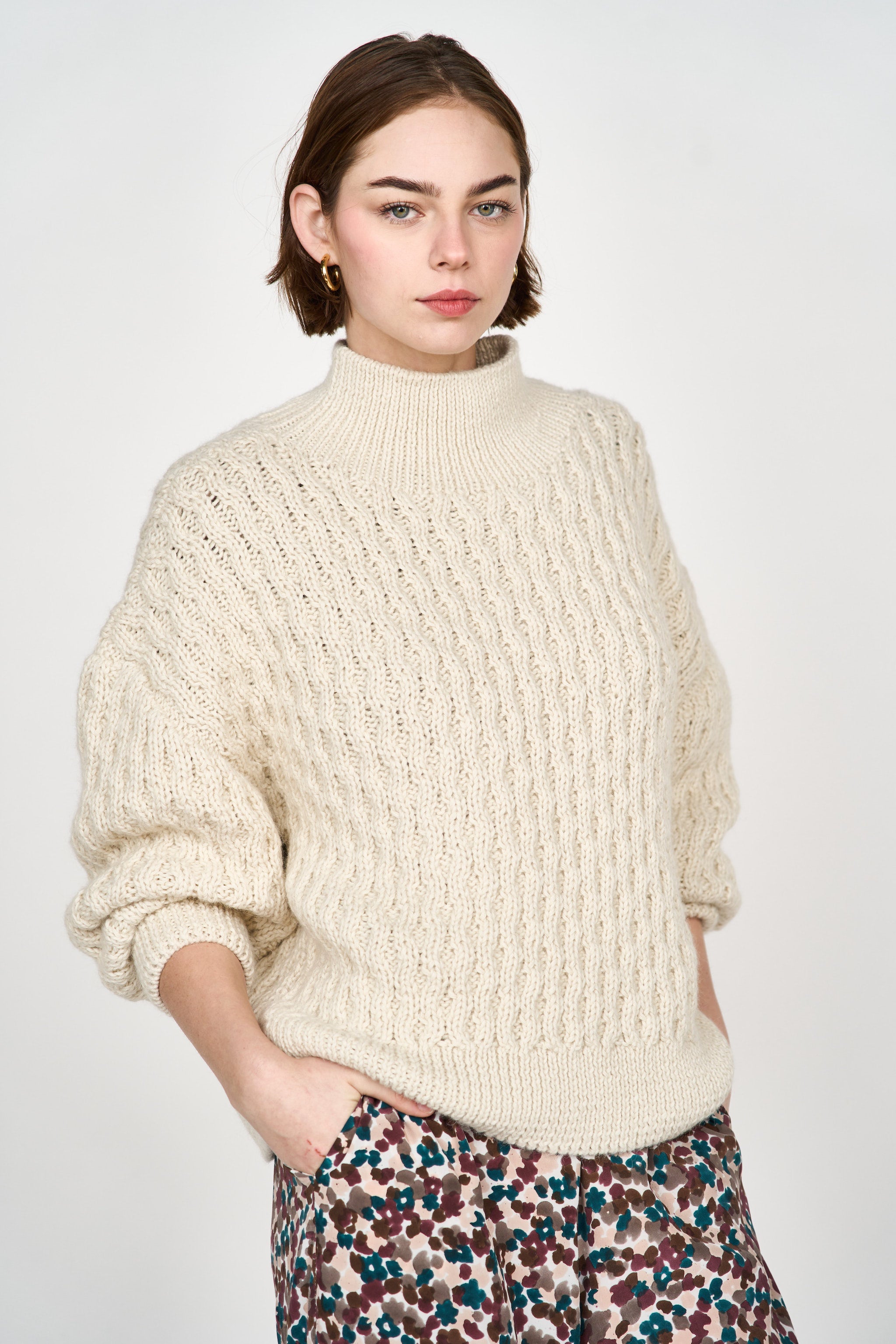 Girl wearing MIRTH women's pullover hand knit honeycomb weave megeve turtleneck sweater in ivory alpaca wool