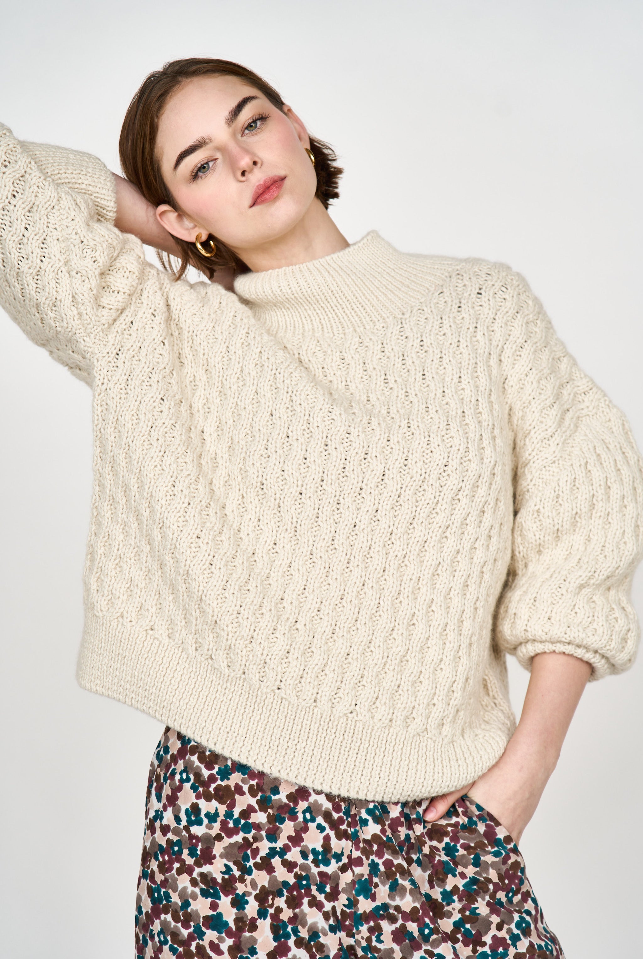 Girl wearing MIRTH women's pullover hand knit honeycomb weave megeve turtleneck sweater in ivory alpaca wool