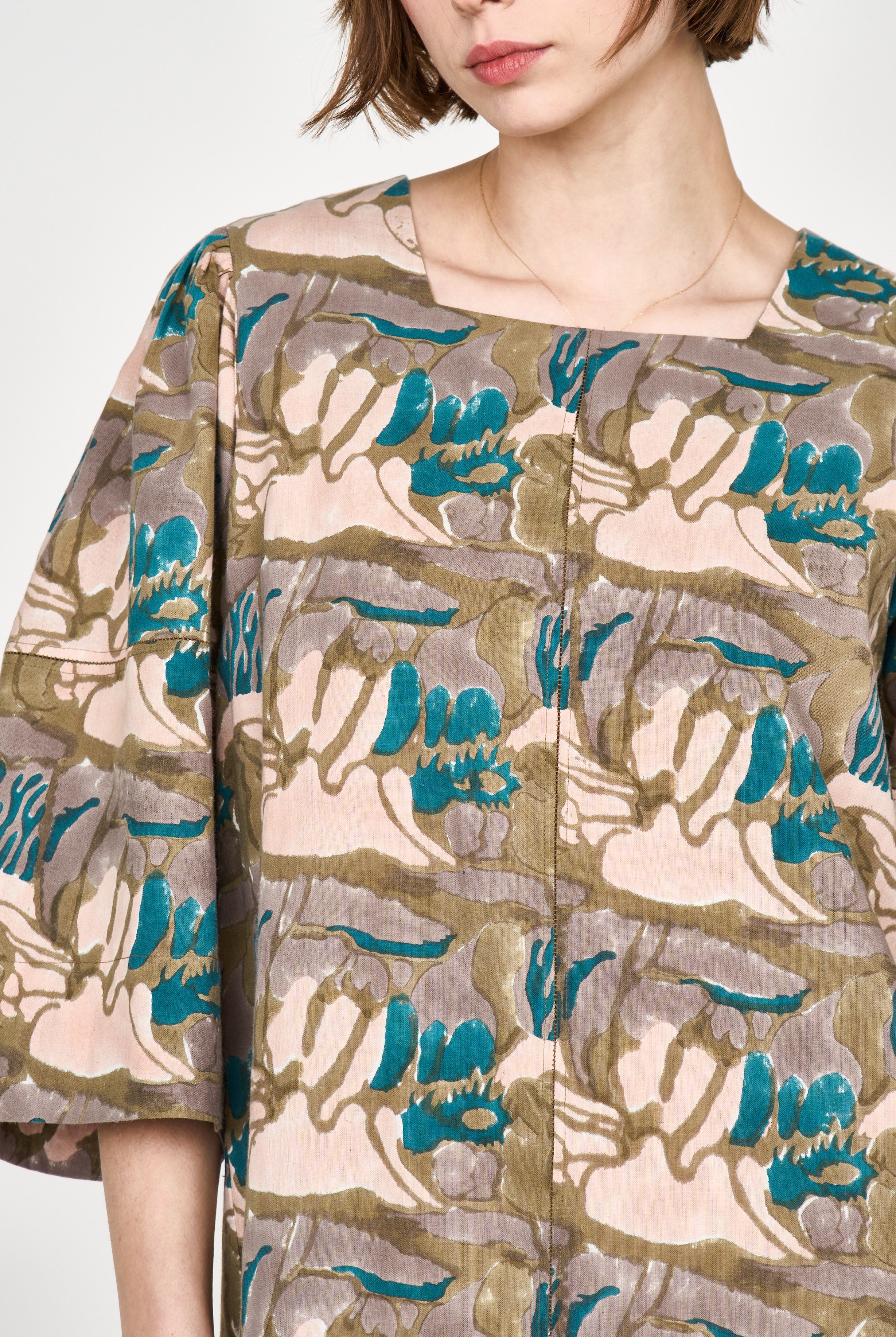 Girl wearing MIRTH women's square neck long caftan dress in brown moss reef blockprint