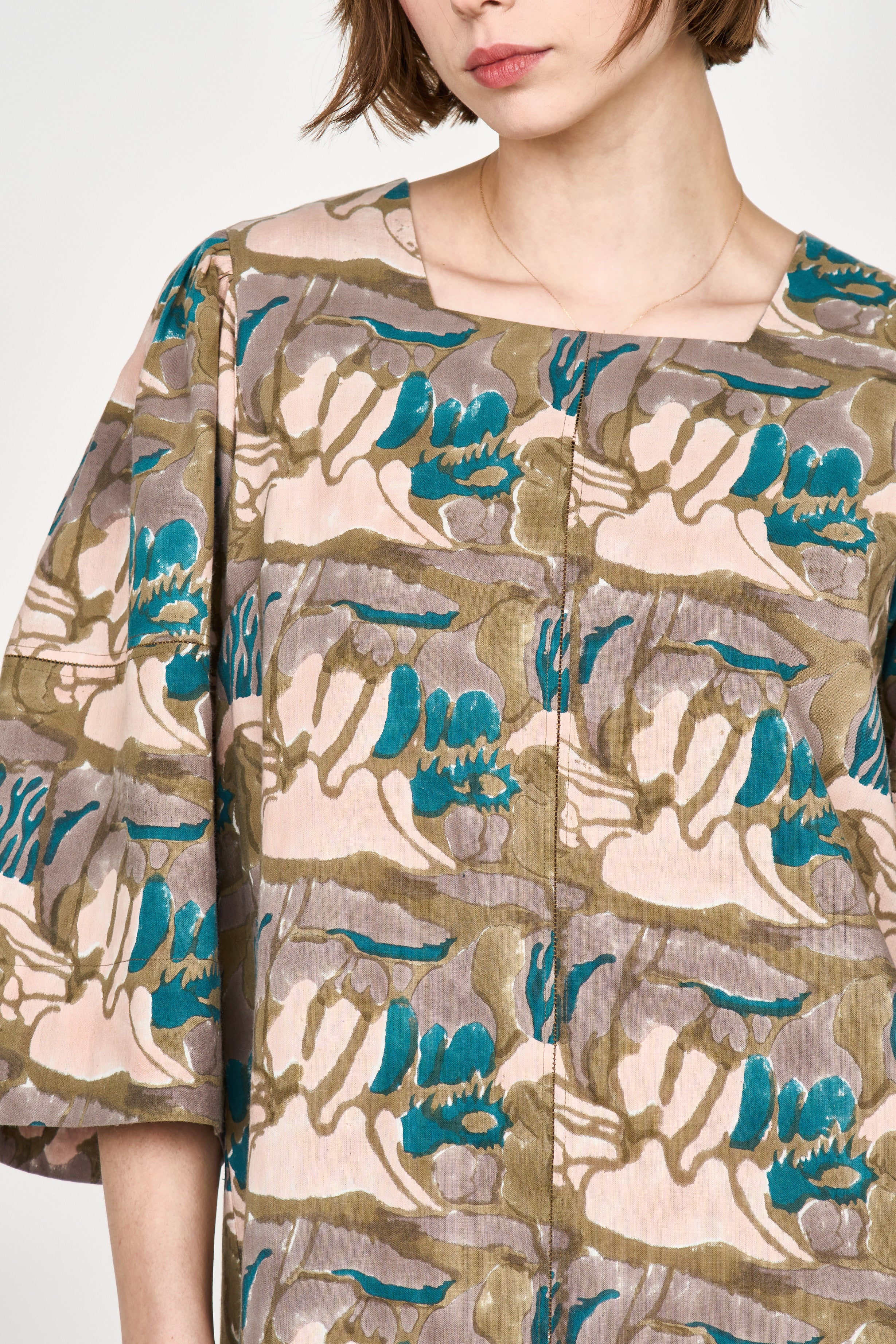 Girl wearing MIRTH women's square neck long caftan dress in brown moss reef blockprint