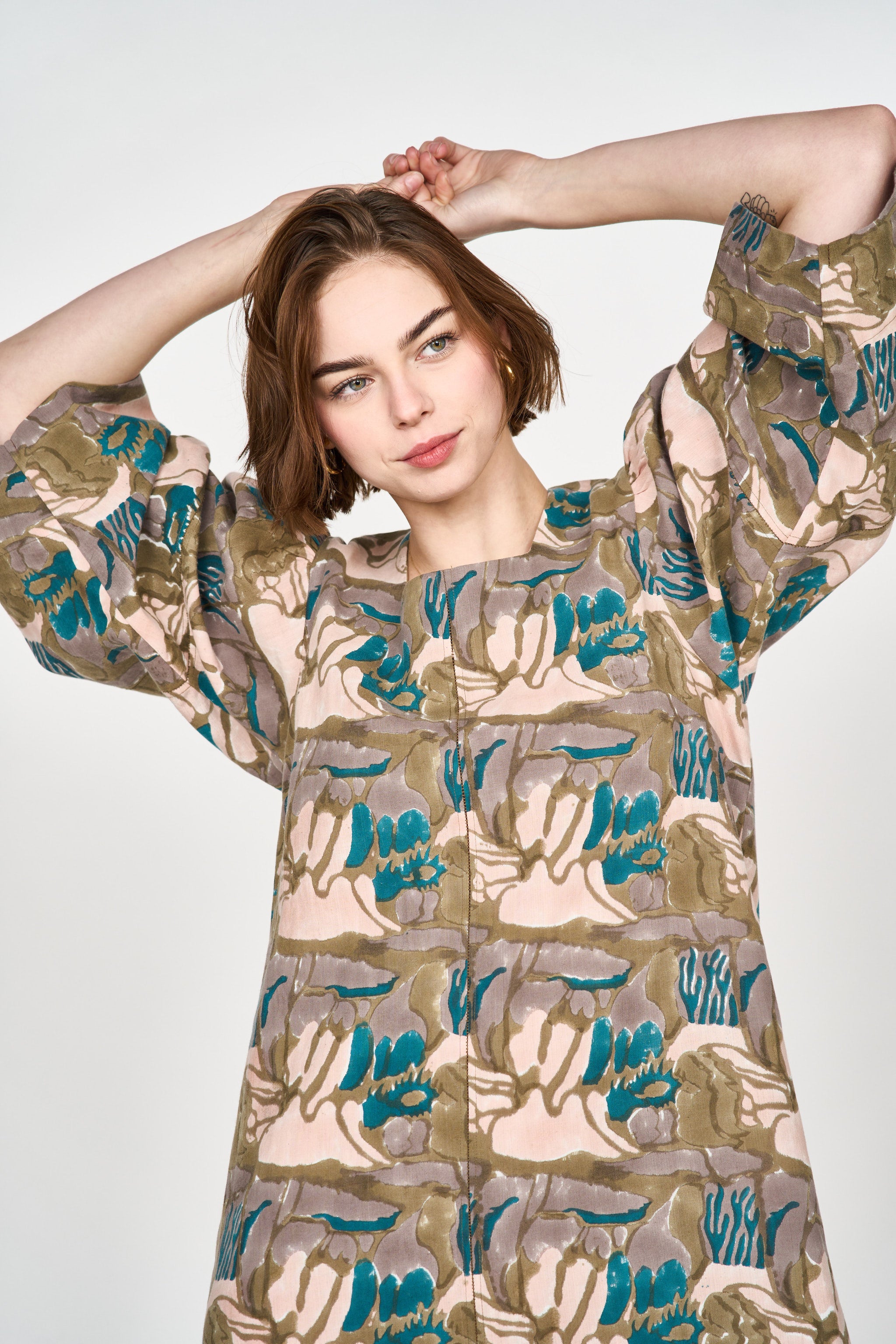 Girl wearing MIRTH women's square neck long caftan dress in brown moss reef blockprint