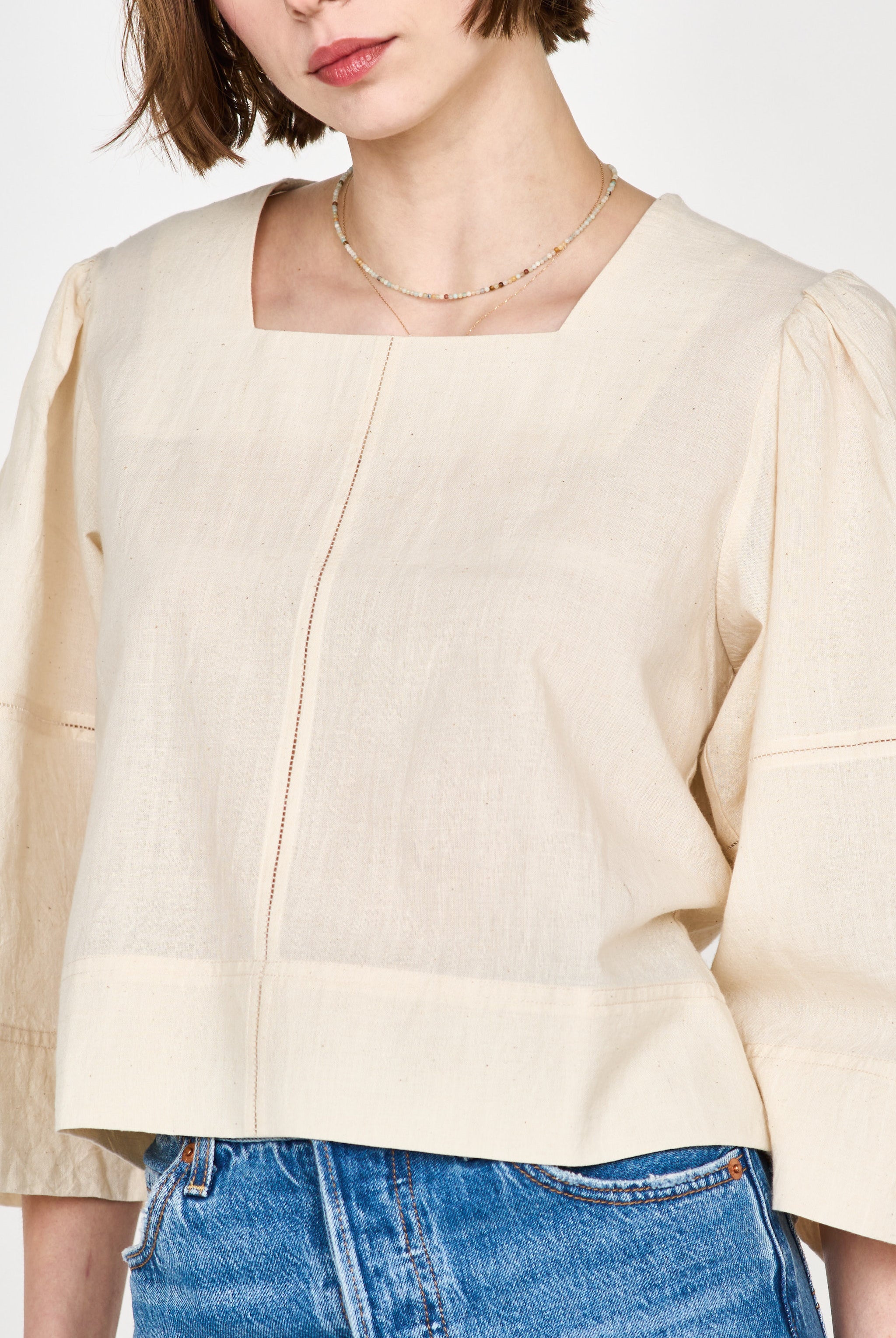 Girl wearing MIRTH women's pullover square neck cropped provence top in cream ecru cotton