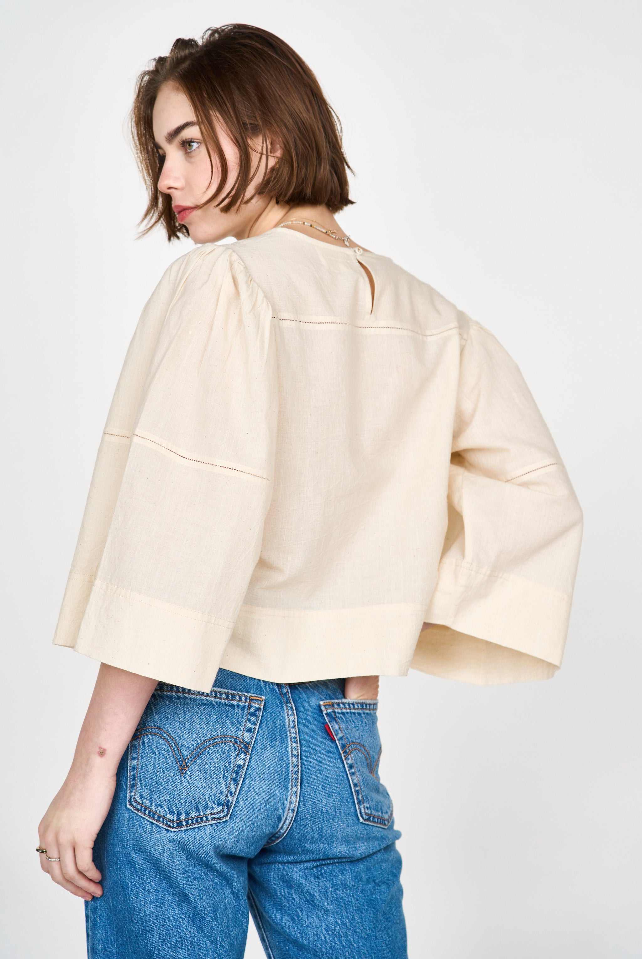 Girl wearing MIRTH women's pullover square neck cropped provence top in cream ecru cotton