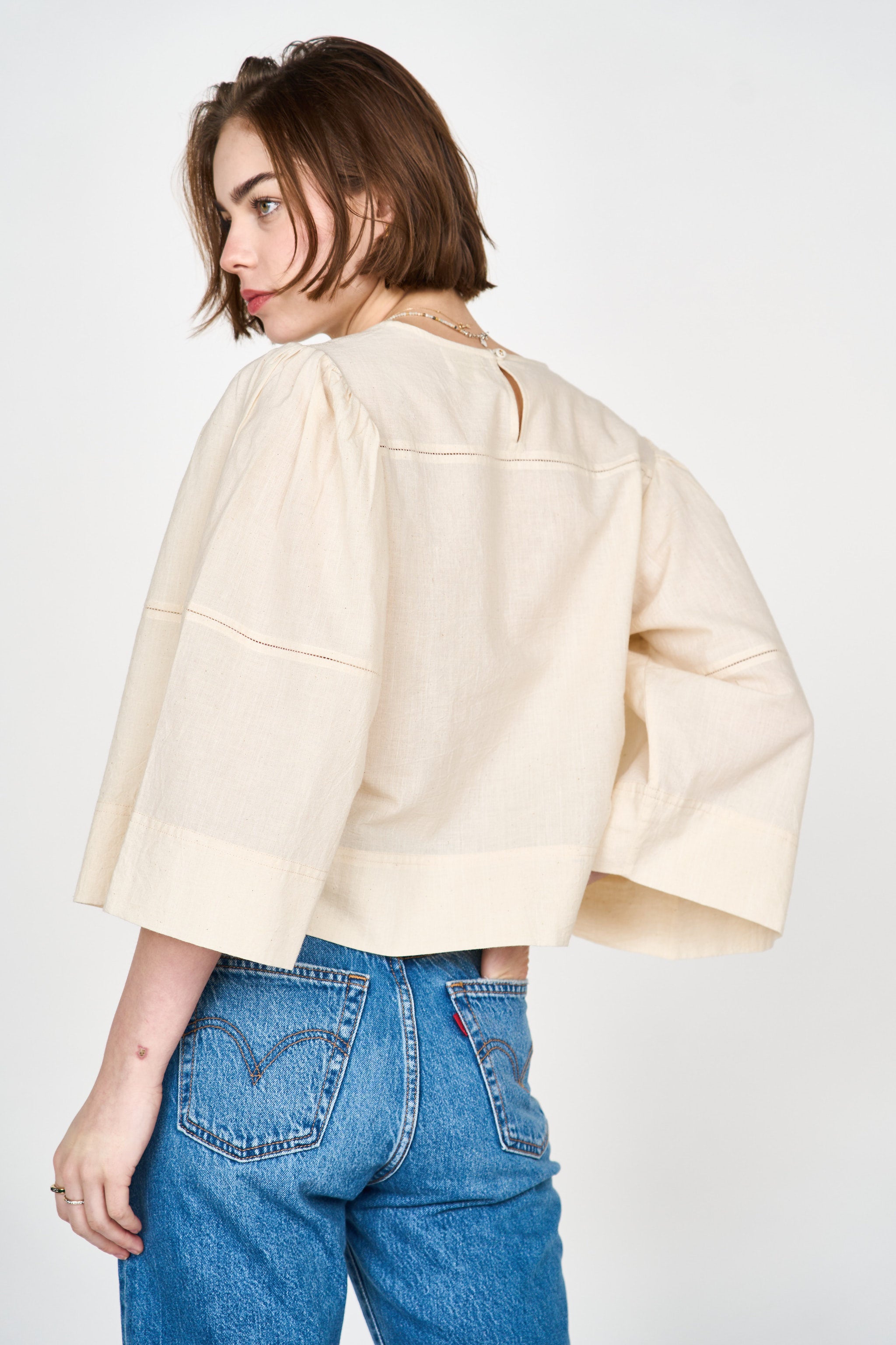 Girl wearing MIRTH women's pullover square neck cropped provence top in cream ecru cotton