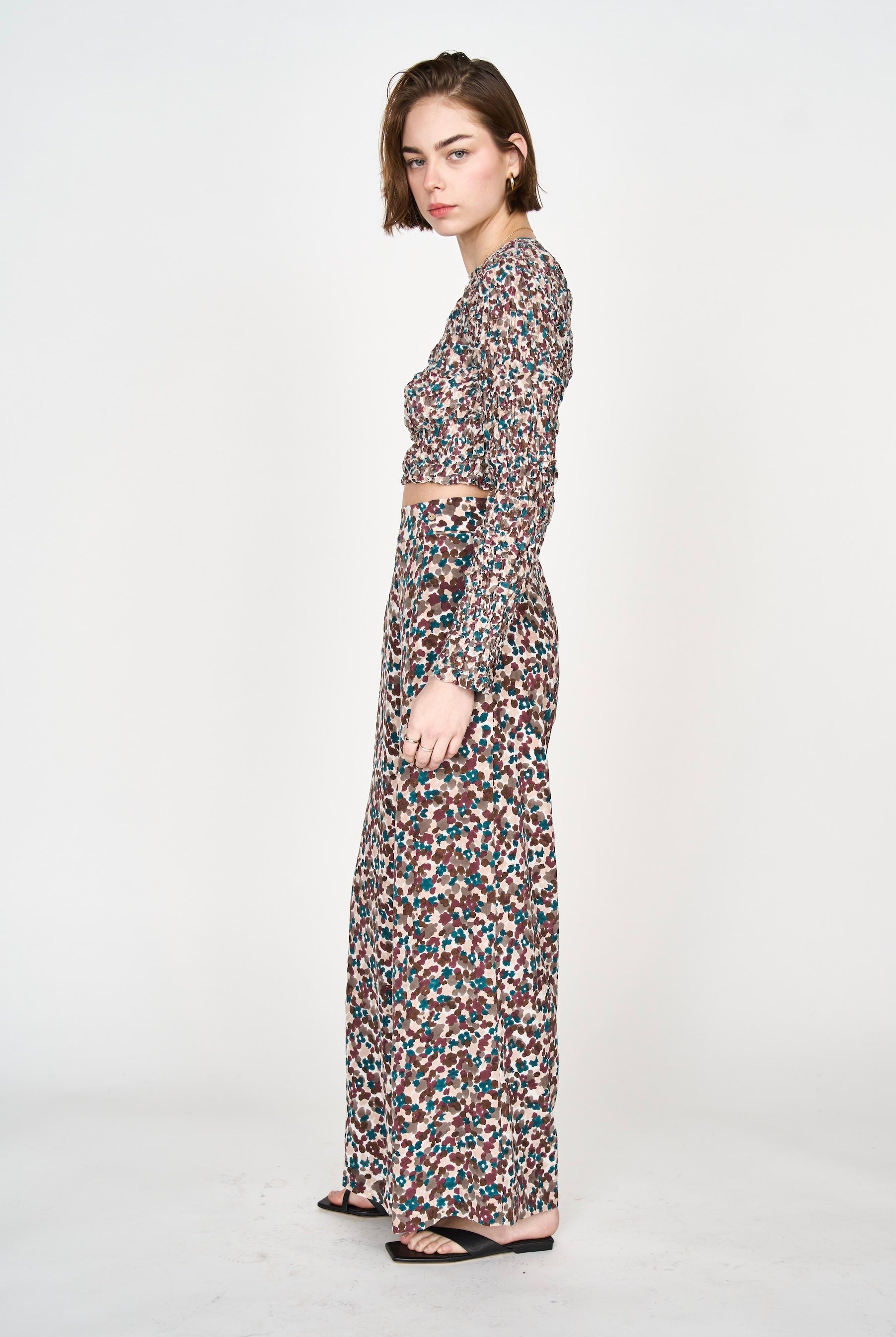 Girl wearing MIRTH women's long sleeve smocked elastic shoreditch top in purple red amaryllis print