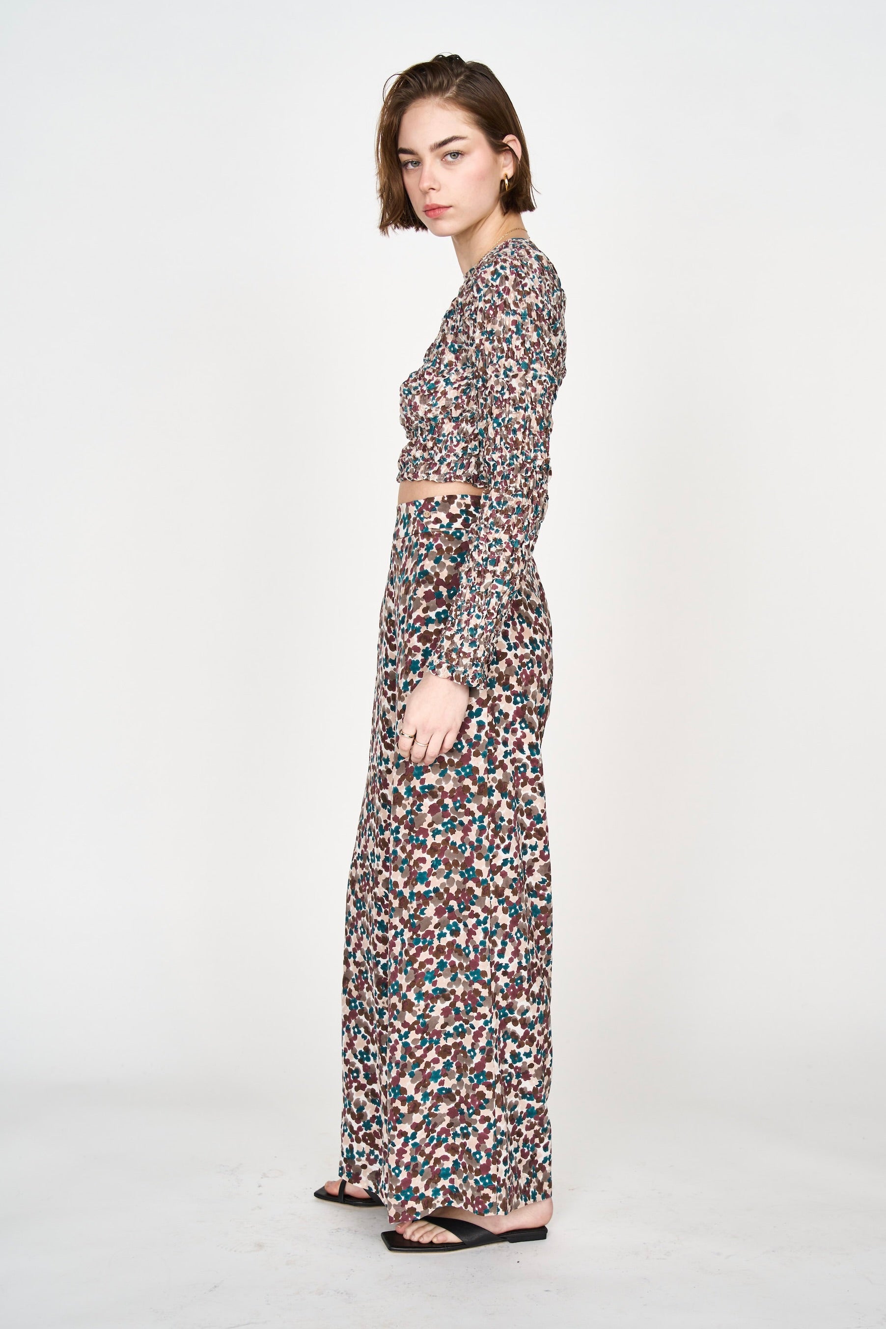 Girl wearing MIRTH women's long sleeve smocked elastic shoreditch top in purple red amaryllis print