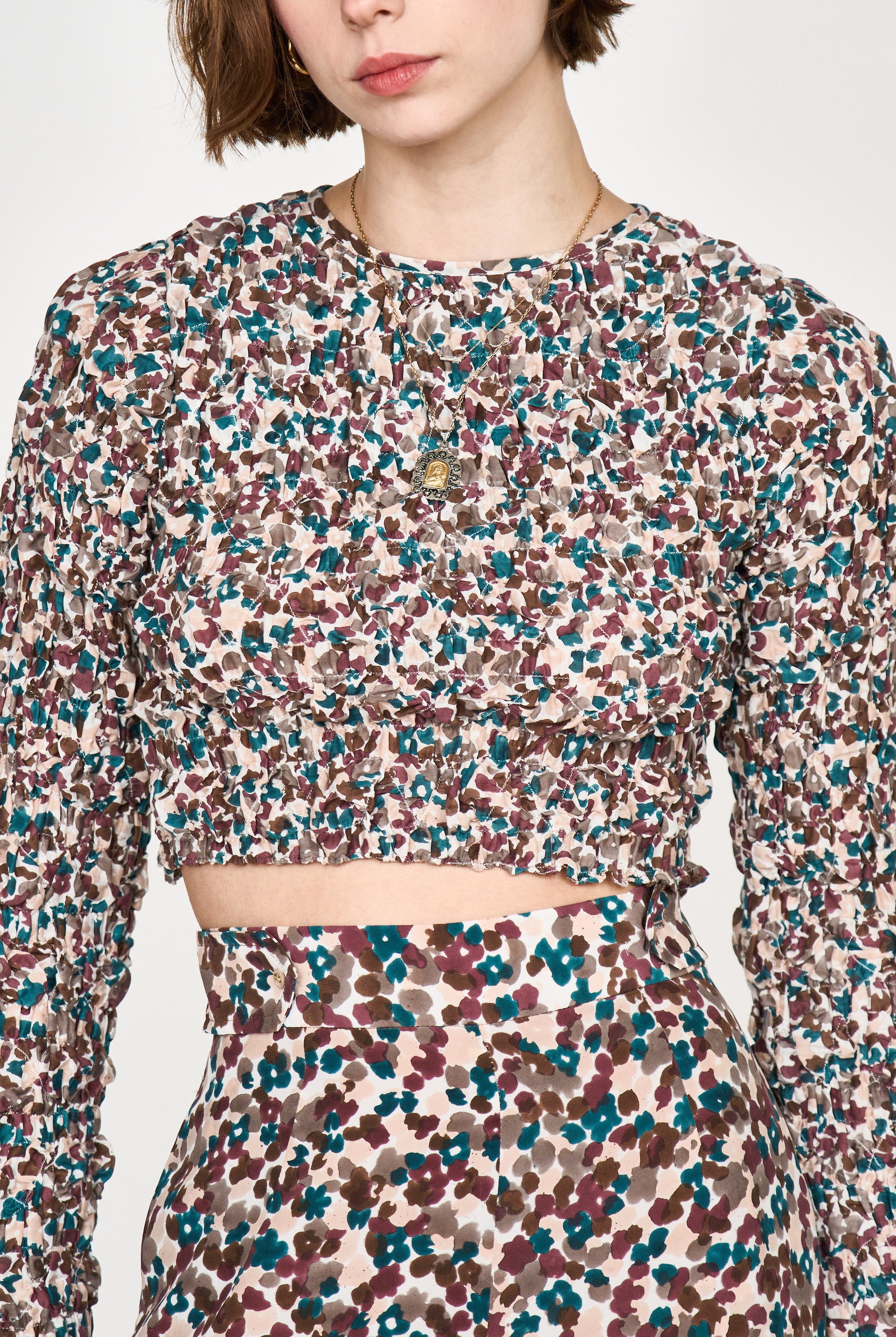 Girl wearing MIRTH women's long sleeve smocked elastic shoreditch top in purple red amaryllis print