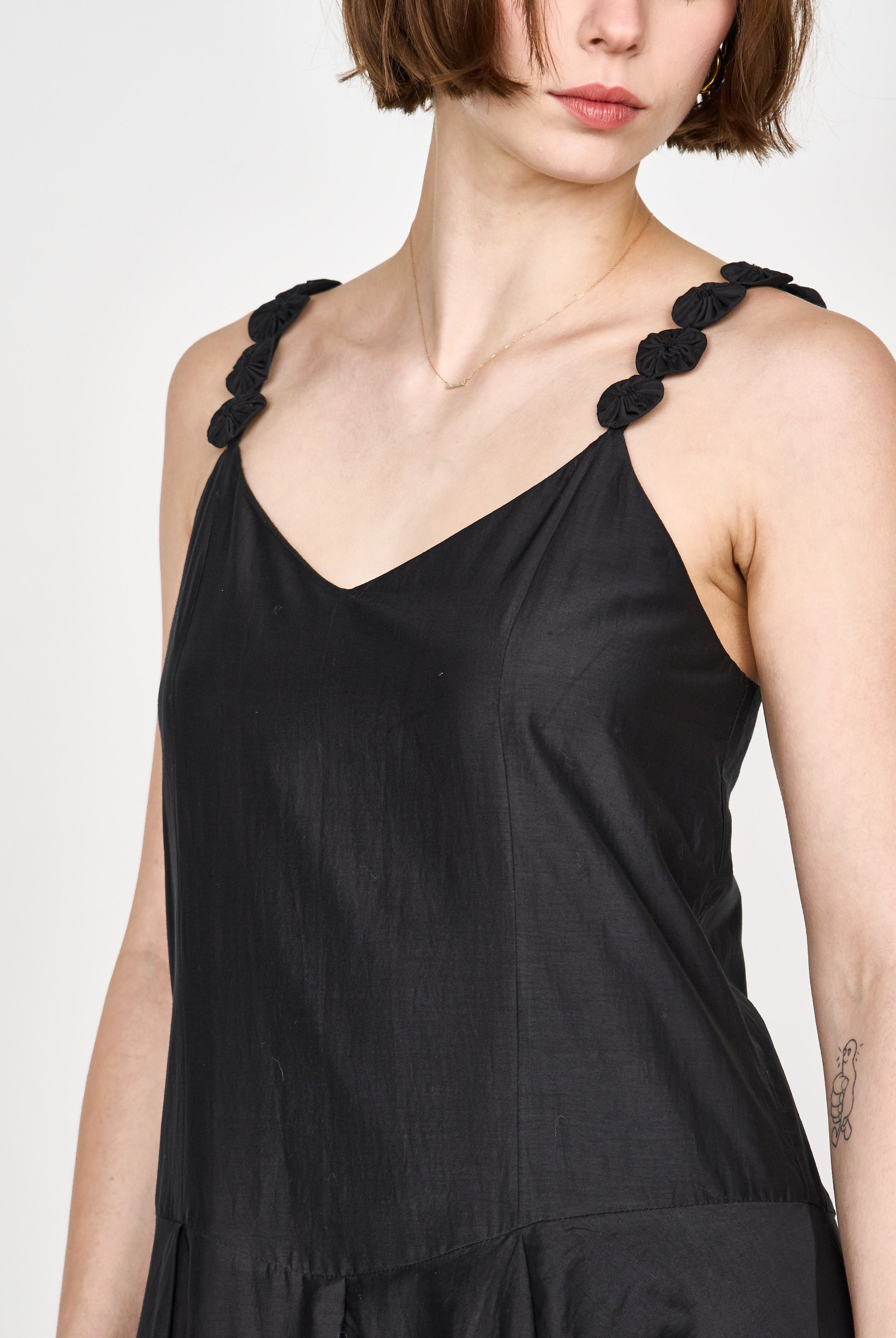 Girl wearing MIRTH women's long singapore spaghetti strap drop waist dress in black cotton silk