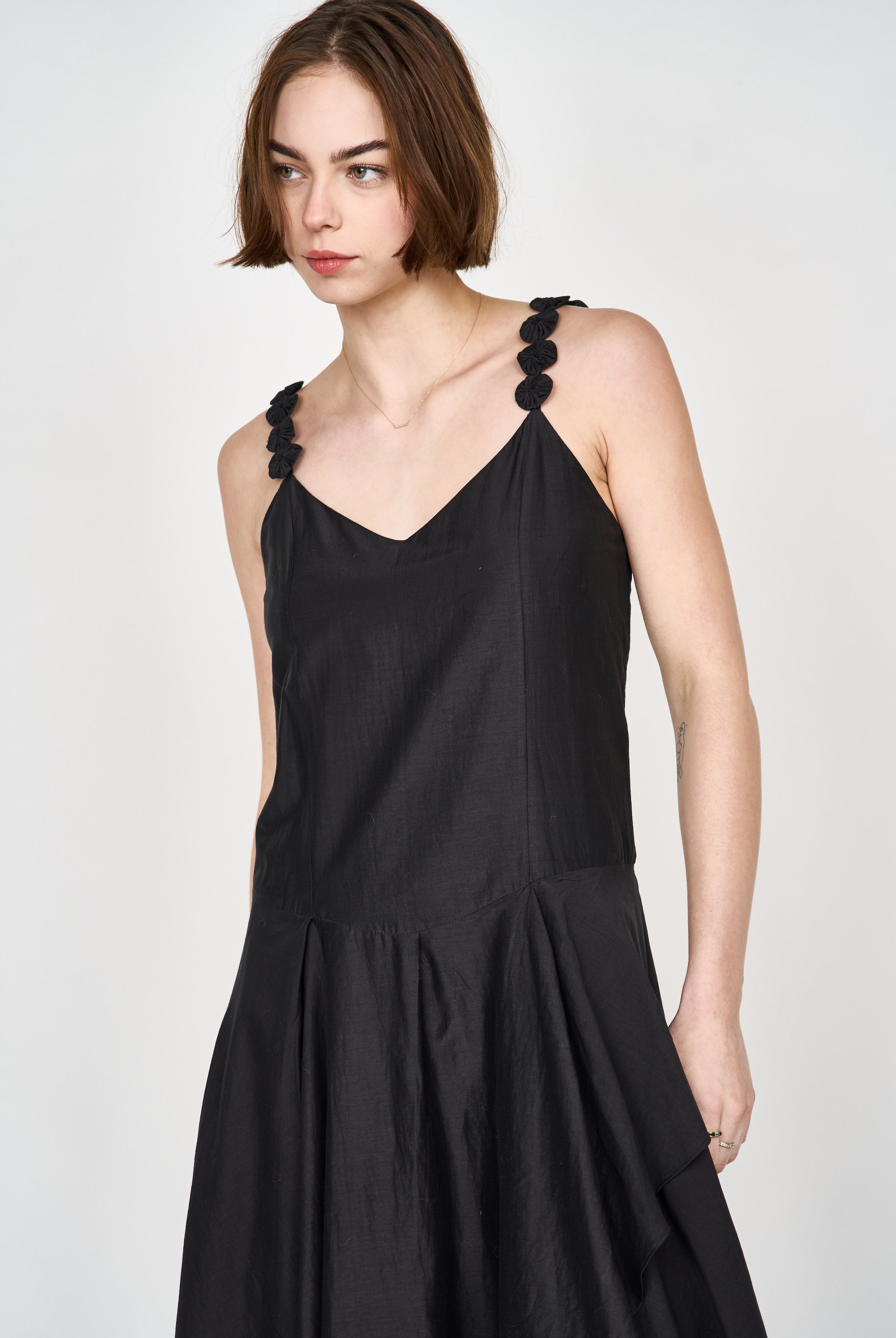 Girl wearing MIRTH women's long singapore spaghetti strap drop waist dress in black cotton silk