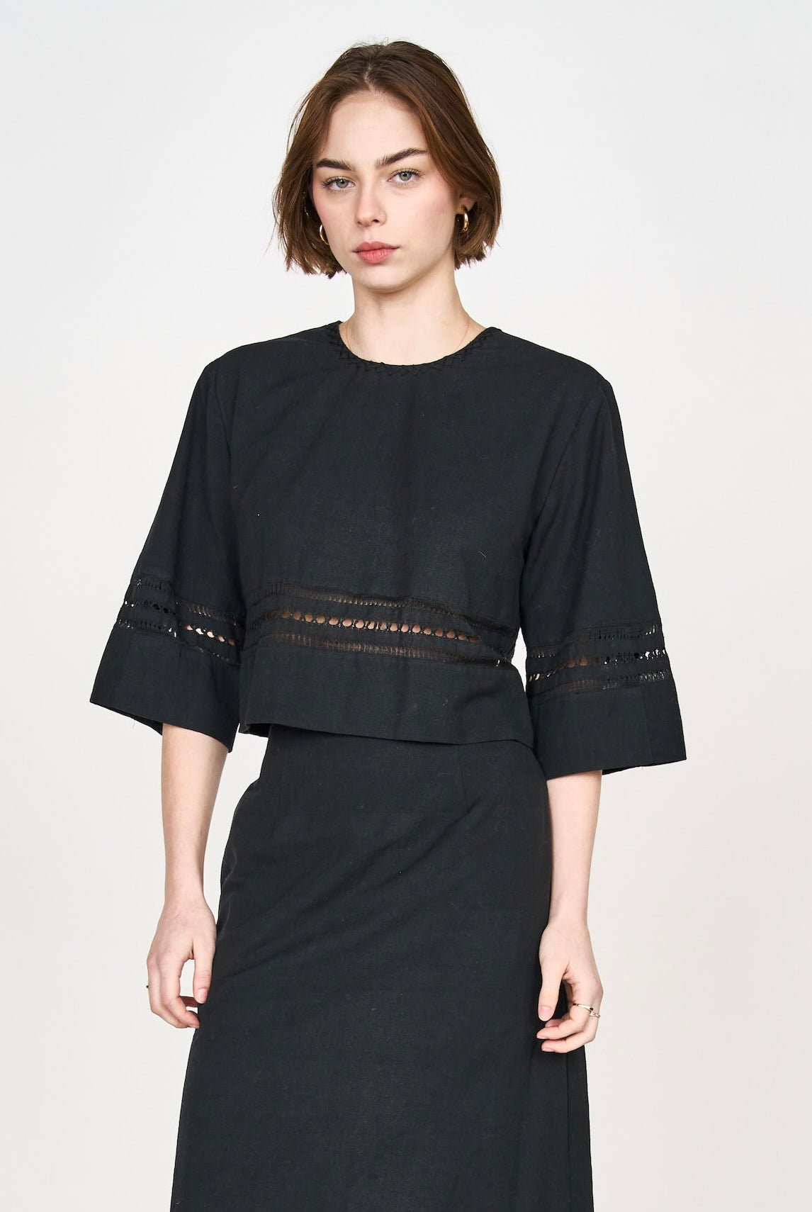 Girl wearing MIRTH women's fringe cutout quarter sleeve sintra top in black cotton