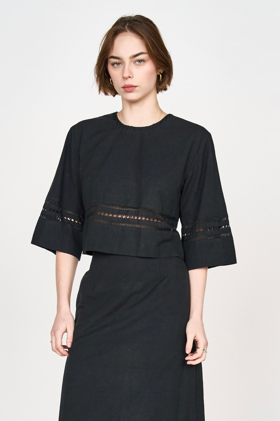 Girl wearing MIRTH women's fringe cutout quarter sleeve sintra top in black cotton