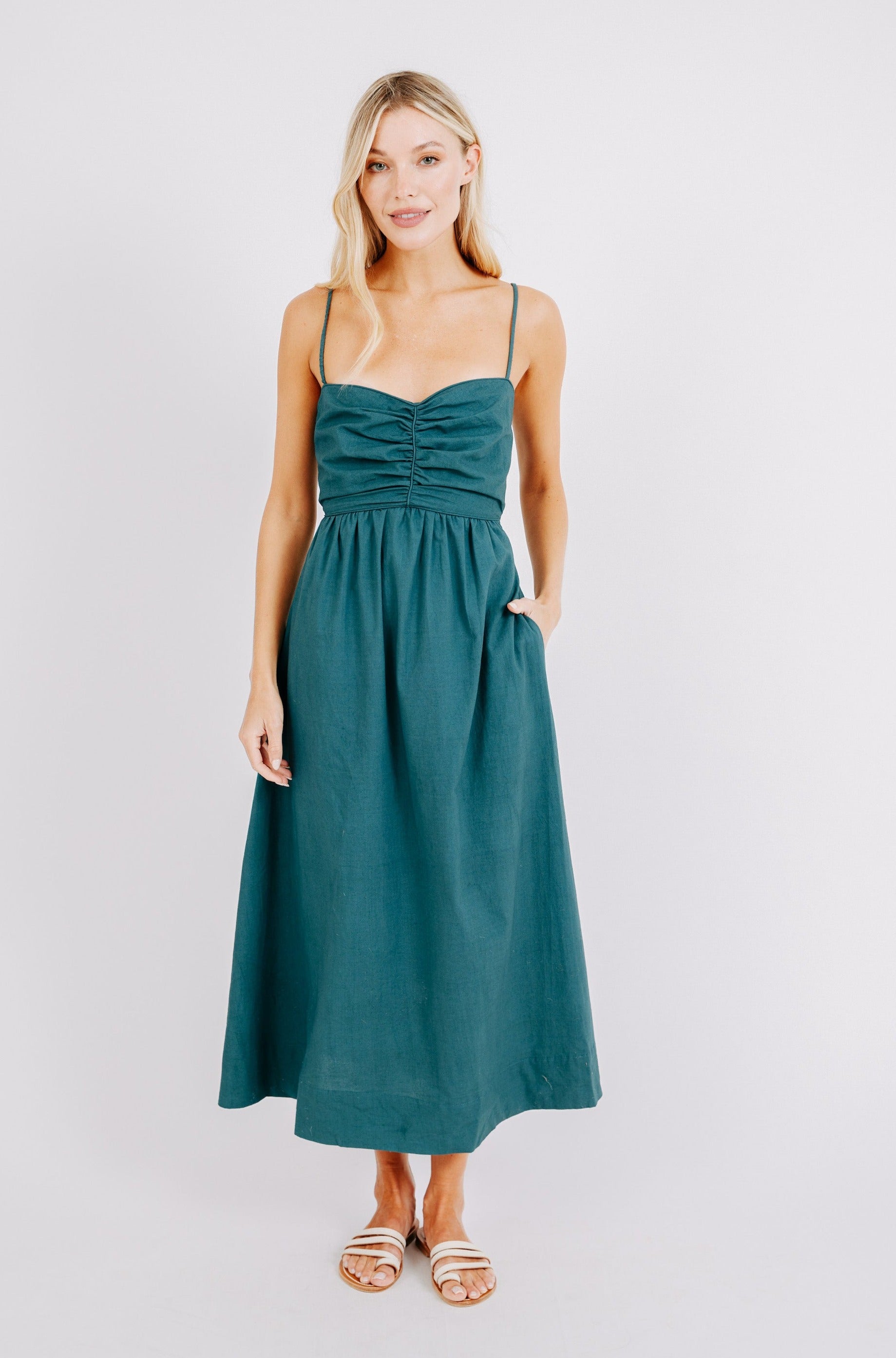 Girl wearing MIRTH women's tie back cutout deia midi sundress in spruce green poplin