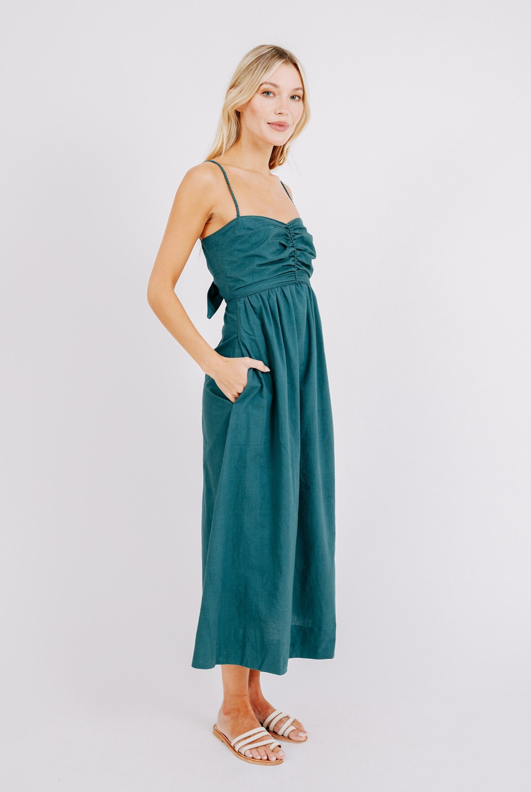 Girl wearing MIRTH women's tie back cutout deia midi sundress in spruce green poplin