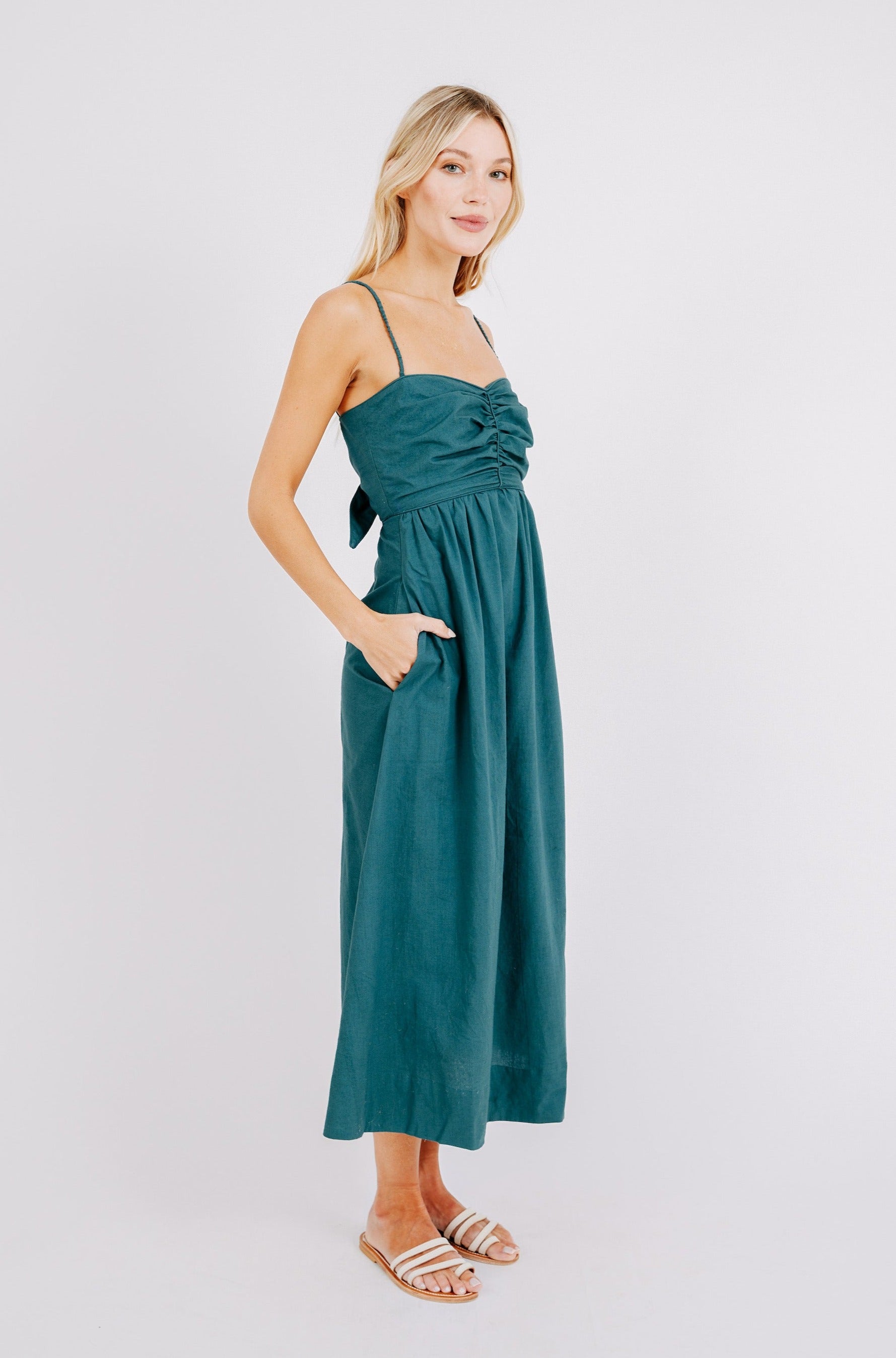 Girl wearing MIRTH women's tie back cutout deia midi sundress in spruce green poplin