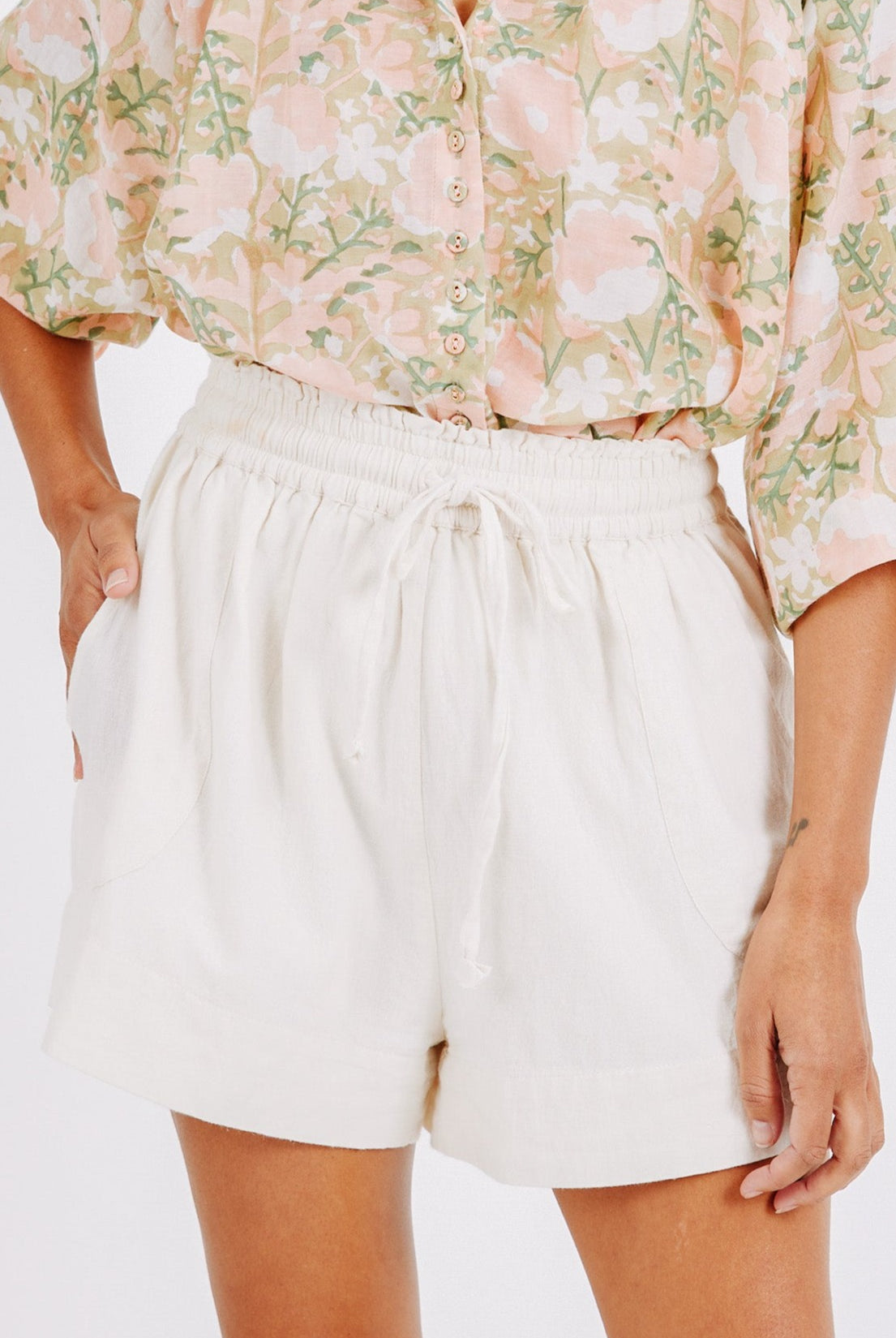 Girl wearing MIRTH women's elastic drawstring woodstock cotton wide leg shorts with pockets in bone cream