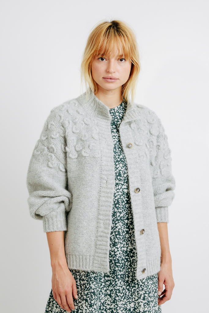 Girl wearing MIRTH women's knit cusco cardigan sweater in dove grey wool