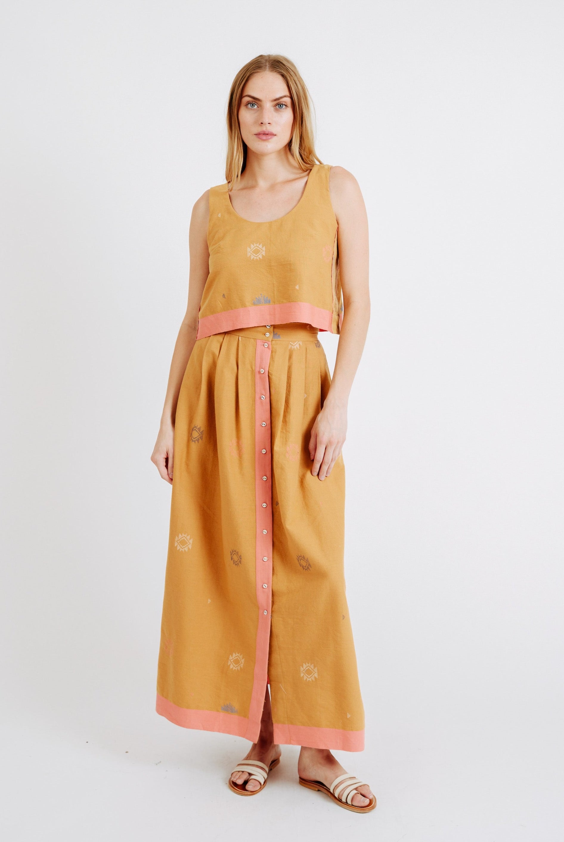 Girl wearing MIRTH women's sleeveless hudson tank top set in handloomed sedona orange jamdani cotton