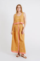 Girl wearing MIRTH women's sleeveless hudson tank top set in handloomed sedona orange jamdani cotton