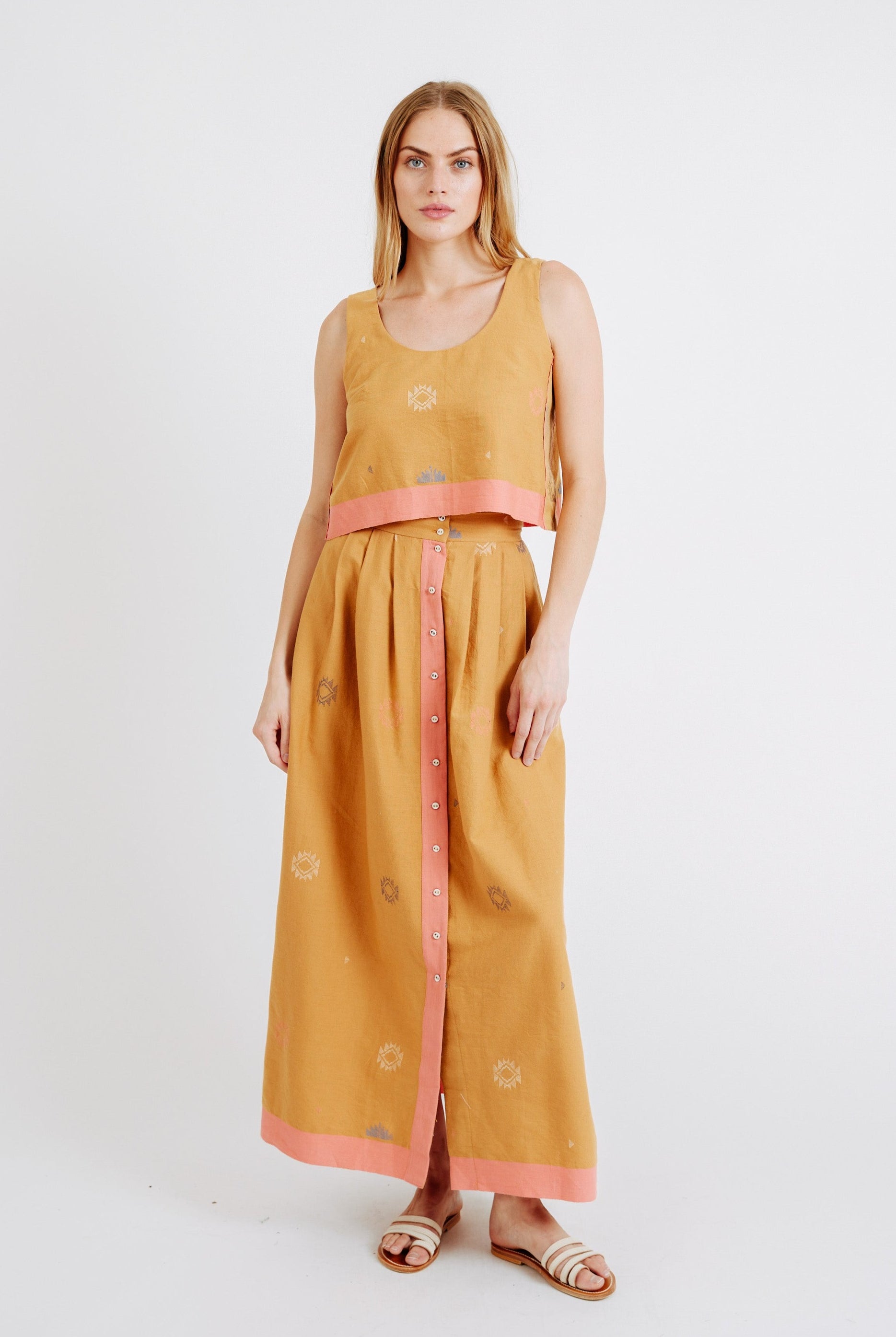 Girl wearing MIRTH women's long lucerne skirt set in handloomed sedona orange jamdani
