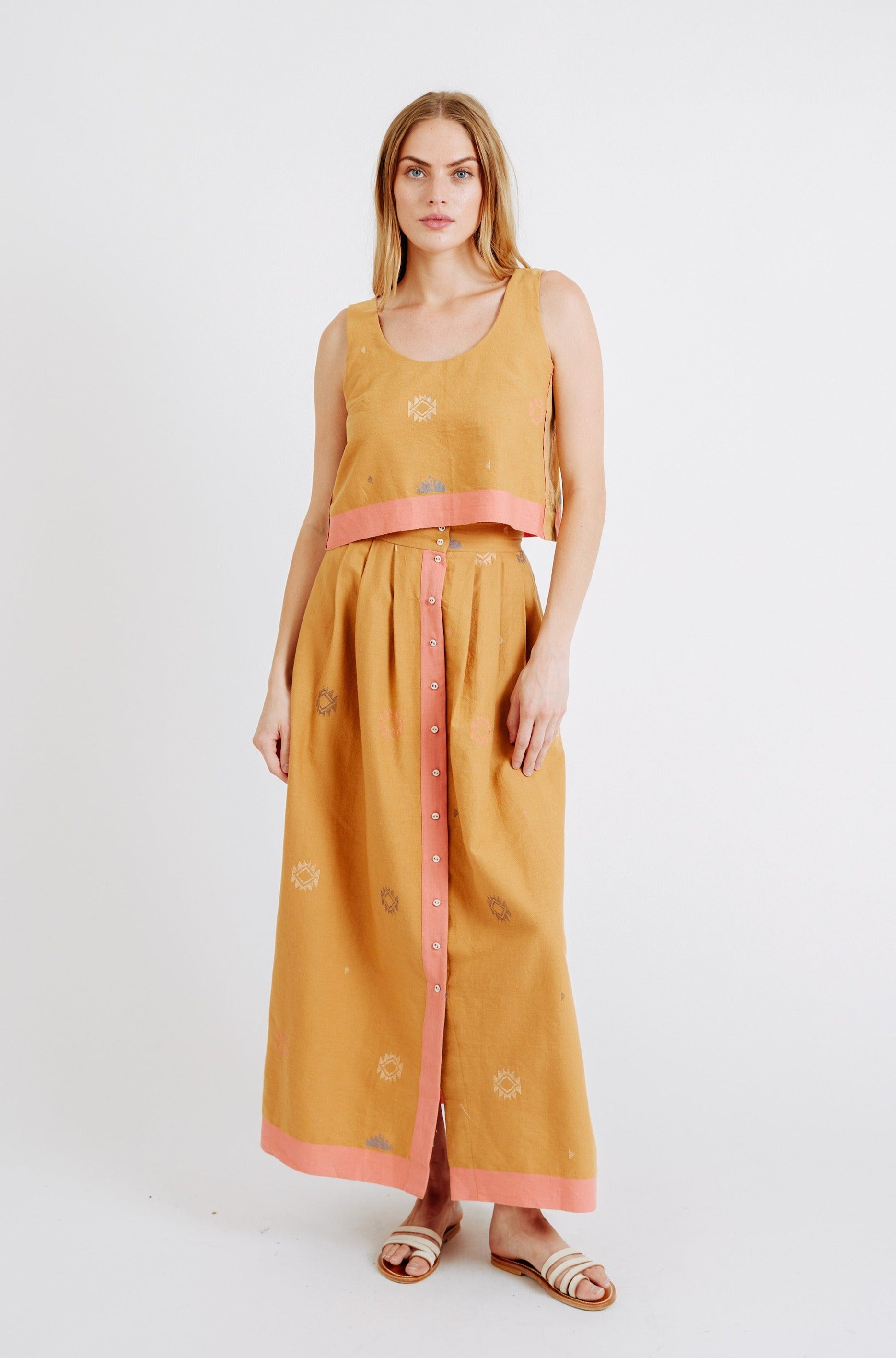 Girl wearing MIRTH women's long lucerne skirt set in handloomed sedona orange jamdani