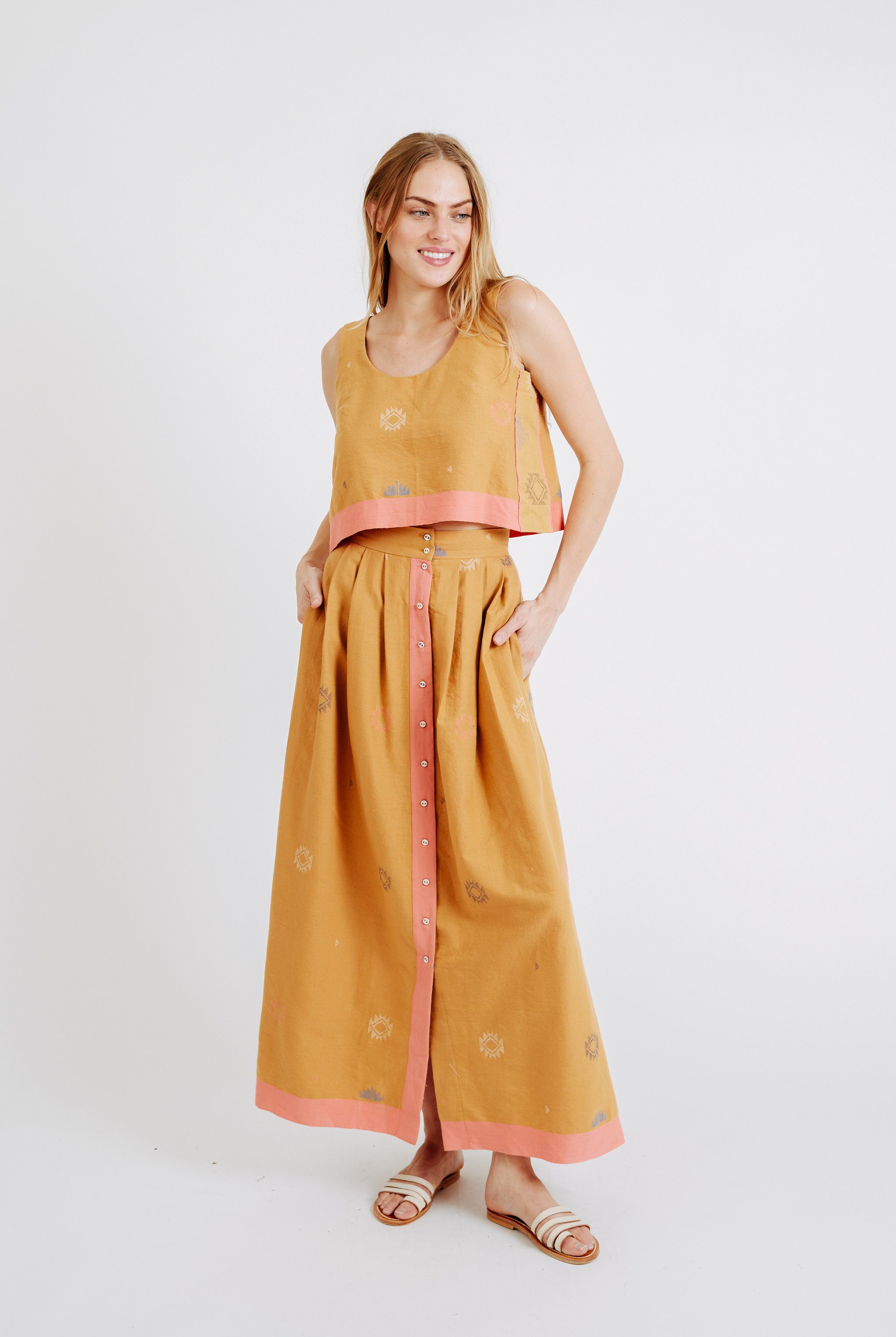 Girl wearing MIRTH women's sleeveless hudson tank top set in handloomed sedona orange jamdani cotton